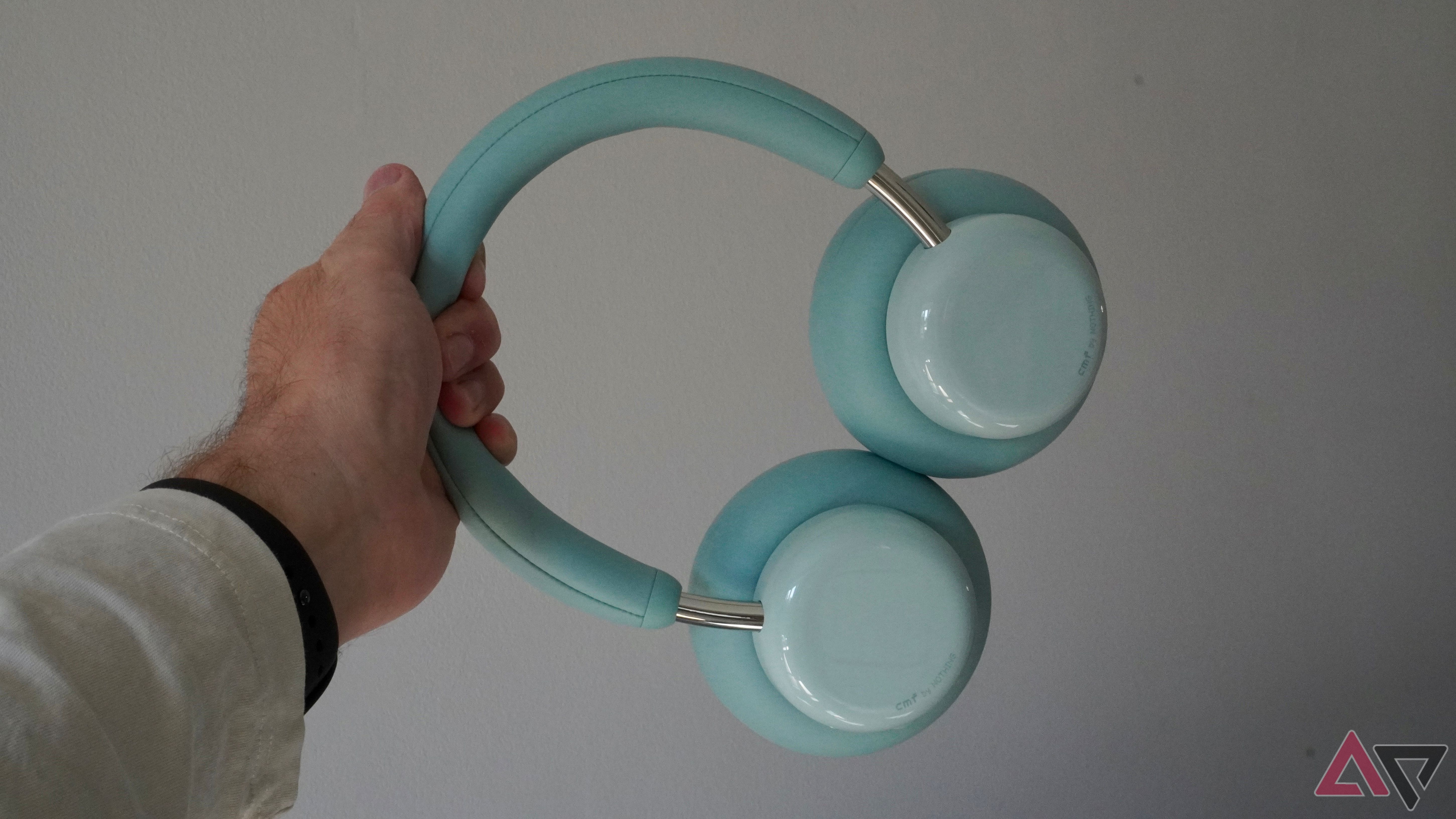 A person holding the CMF Headphone Pro