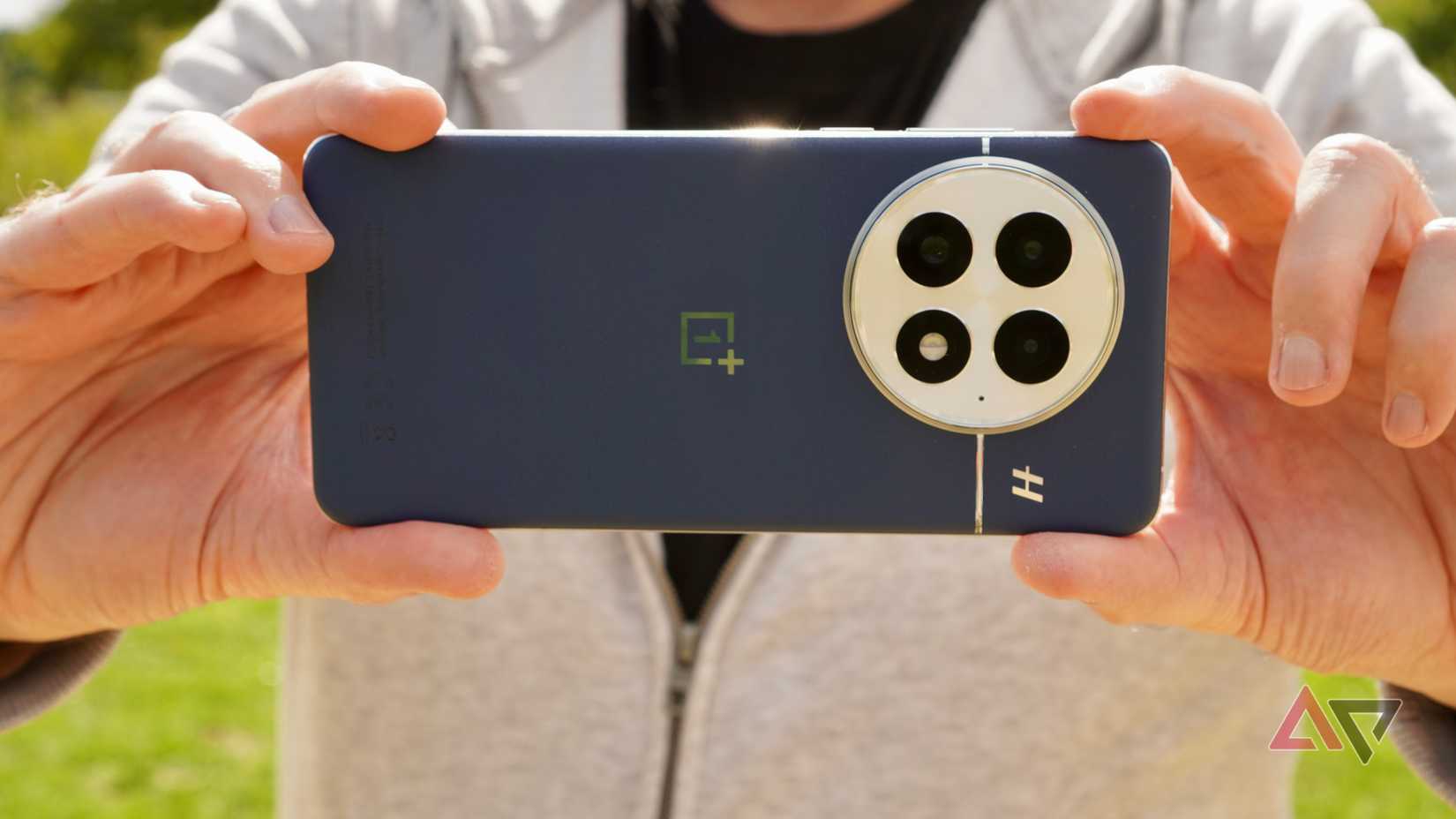 A person taking a photo with the OnePlus 13