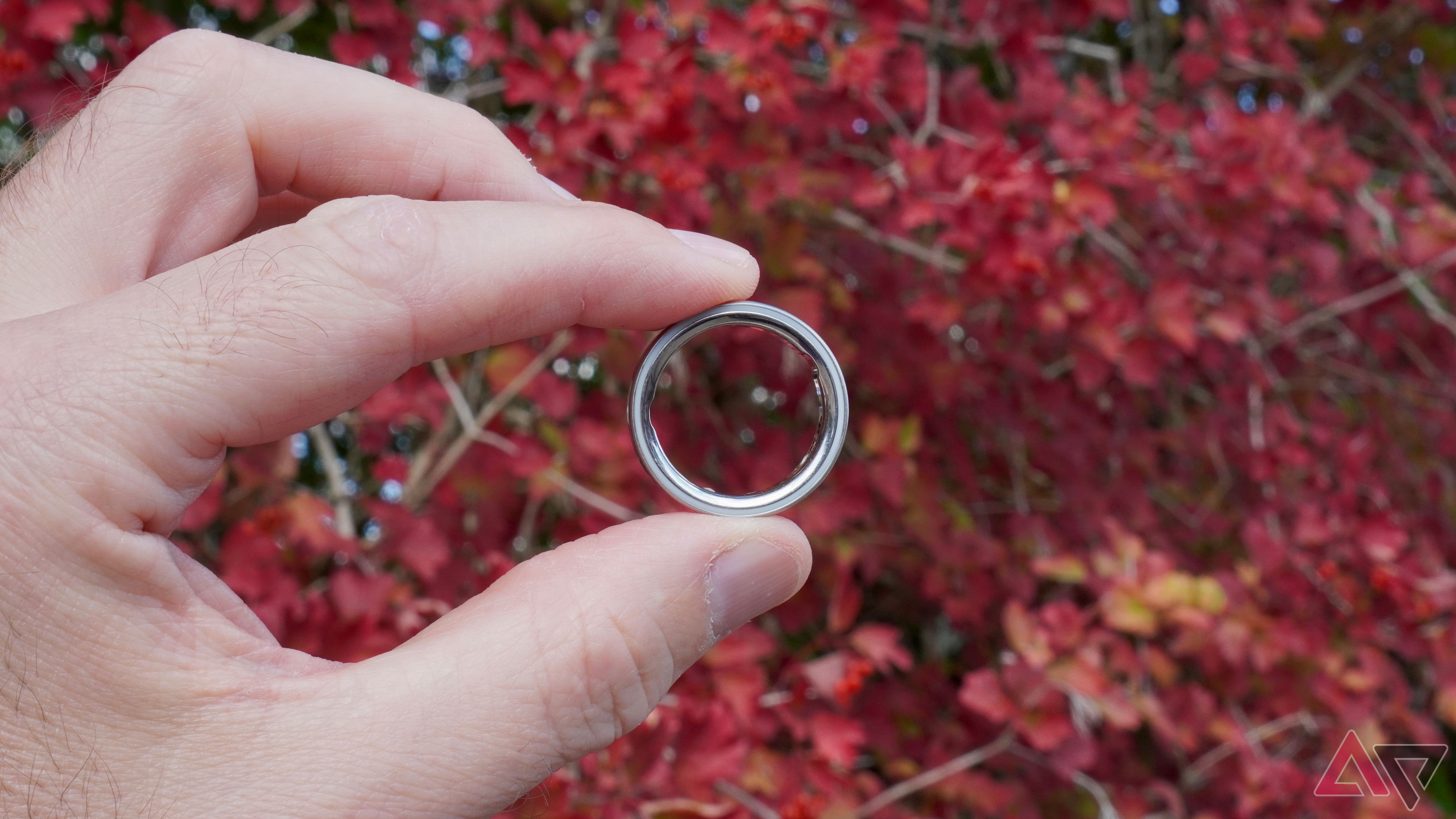 A person holding the Oura Ring 4