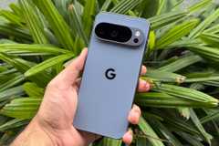 Google Pixel 10 Pro in hand in front of green leaves