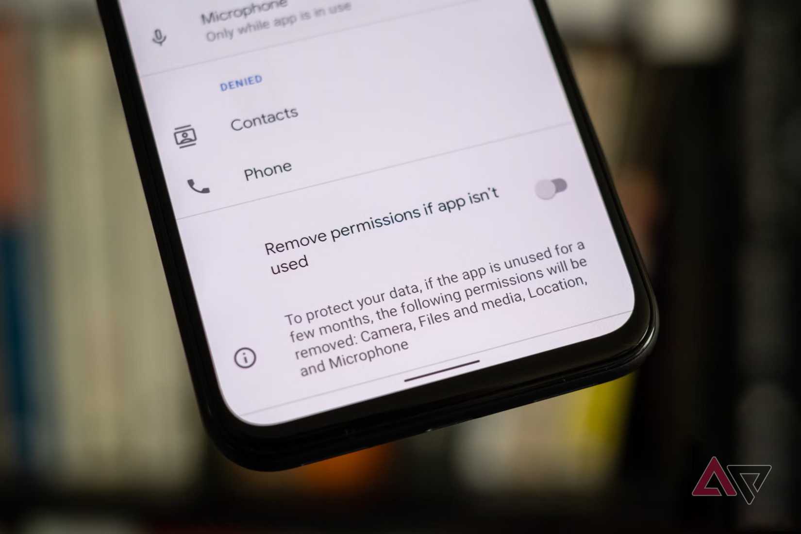 a phone showing a toggle to remove app permission