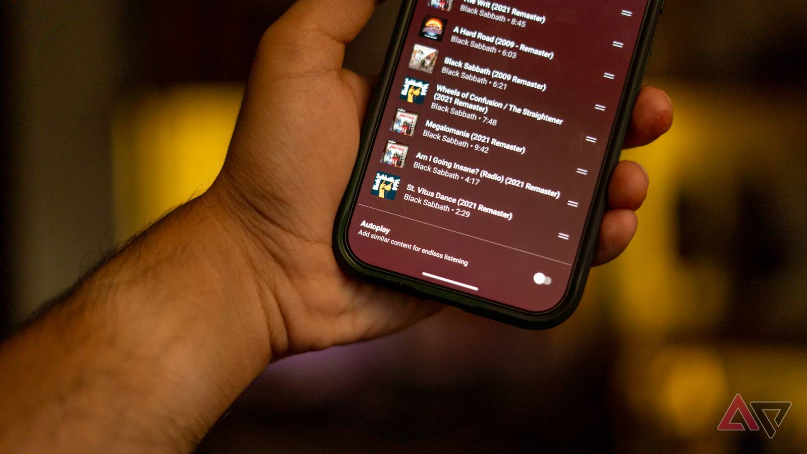 A phone showing YouTube Music with auto play turned off