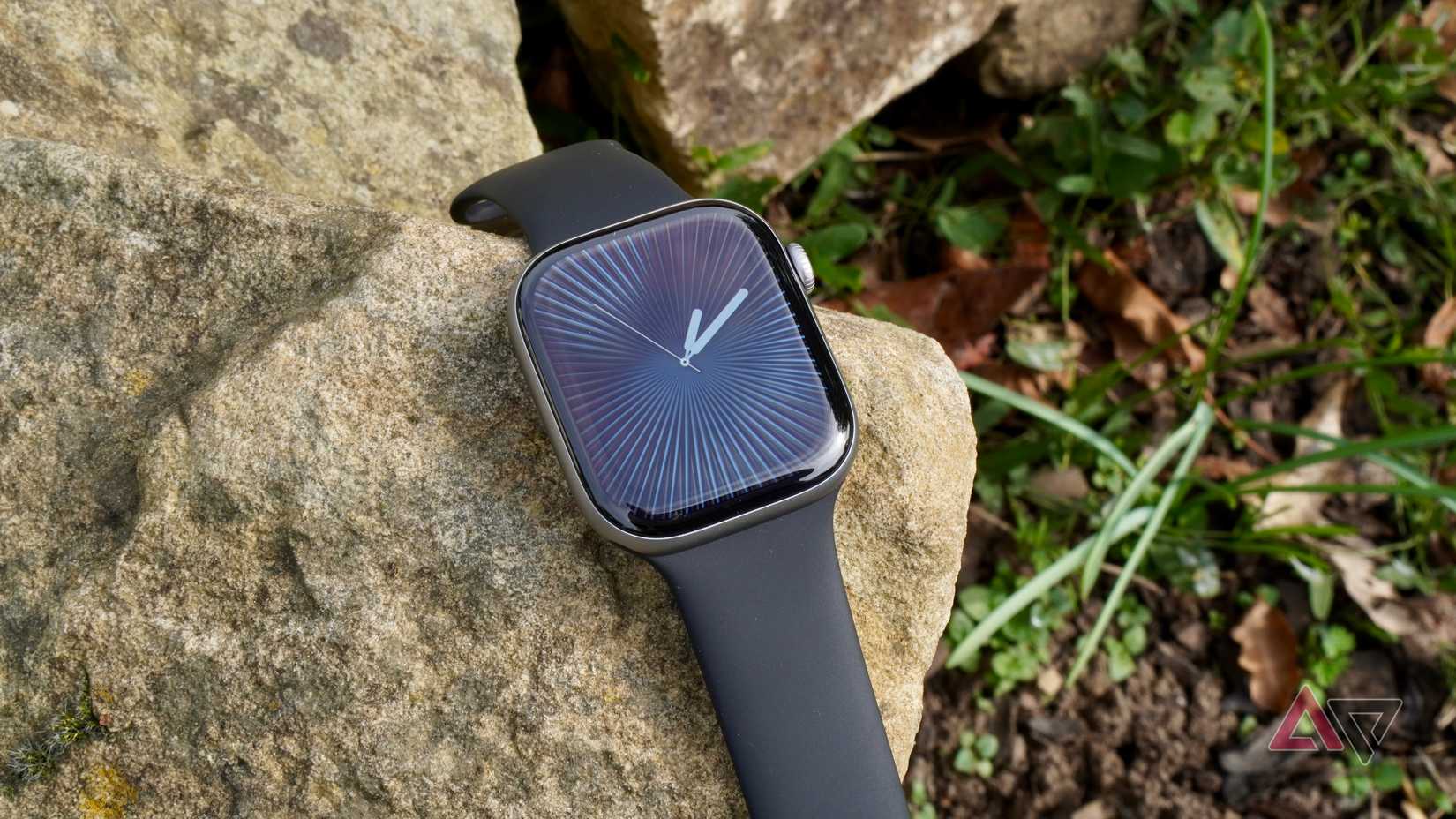 The Apple Watch Series 11 on a rock