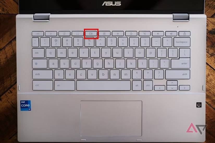 A silver Chromebook keyboard with the "Show all windows" key highlighted in red