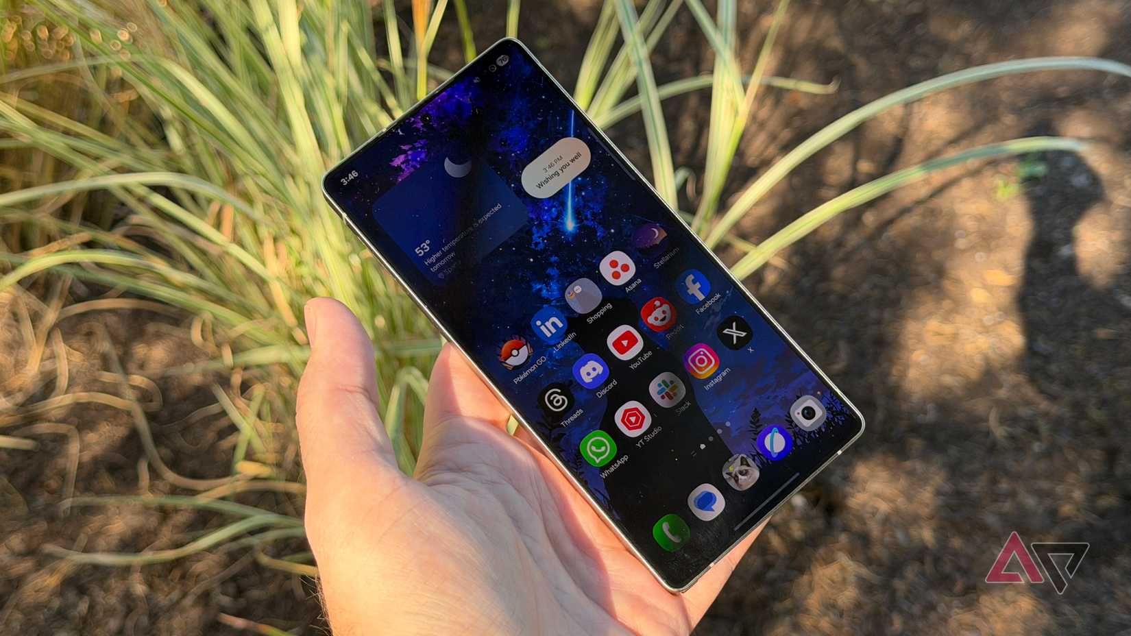 Samsung Galaxy S25 Ultra held up against grass