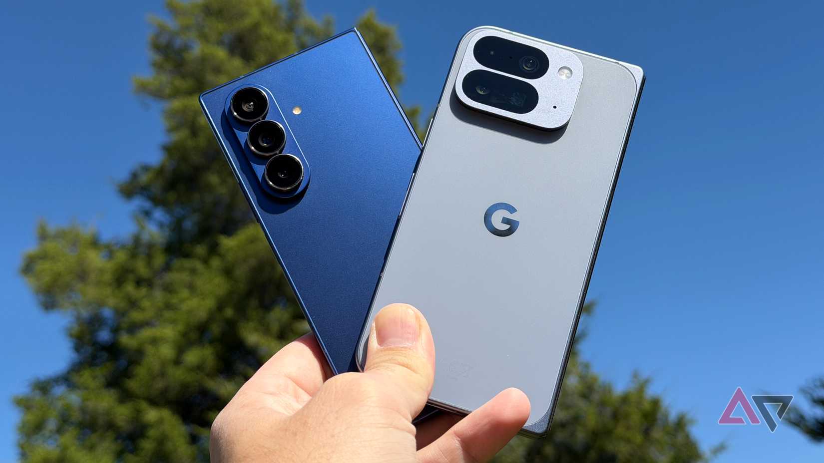 Google Pixel 10 Pro Fold and Samsung Galaxy Z Fold 7 held against the sky