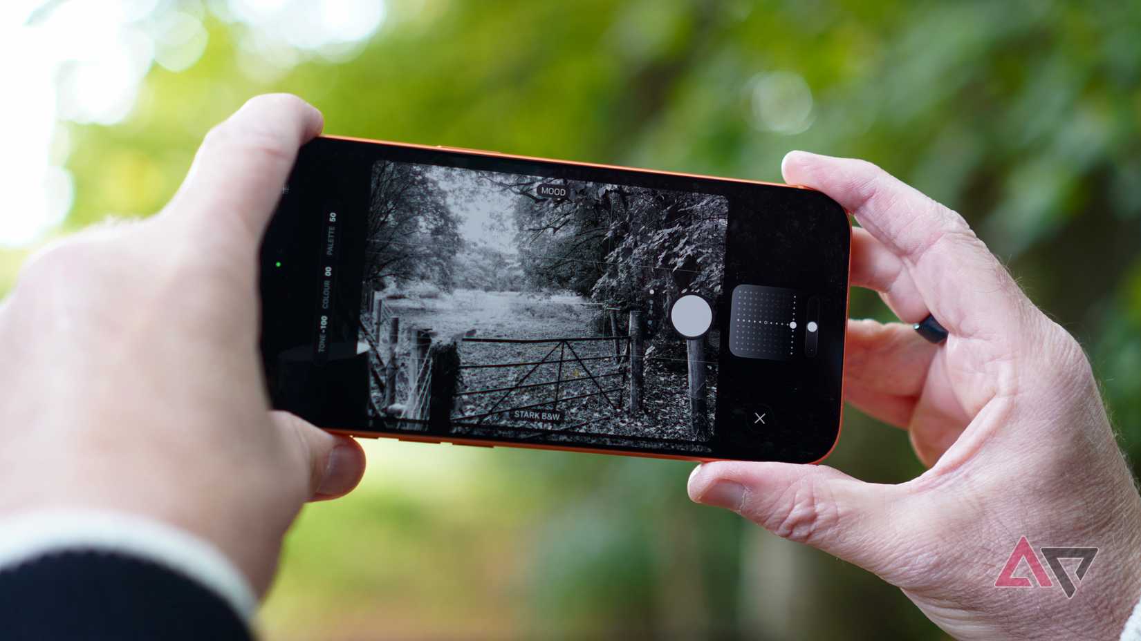 A person taking a photo with the Apple iPhone 17 Pro Max, using Photographic Styles