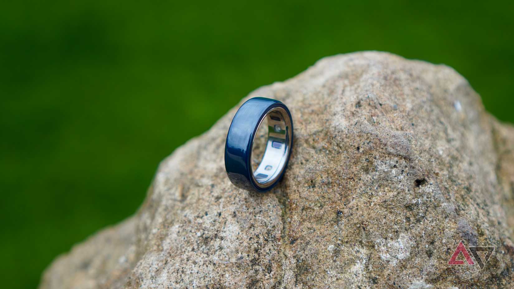 The Oura Ring 4 Ceramic on a rock
