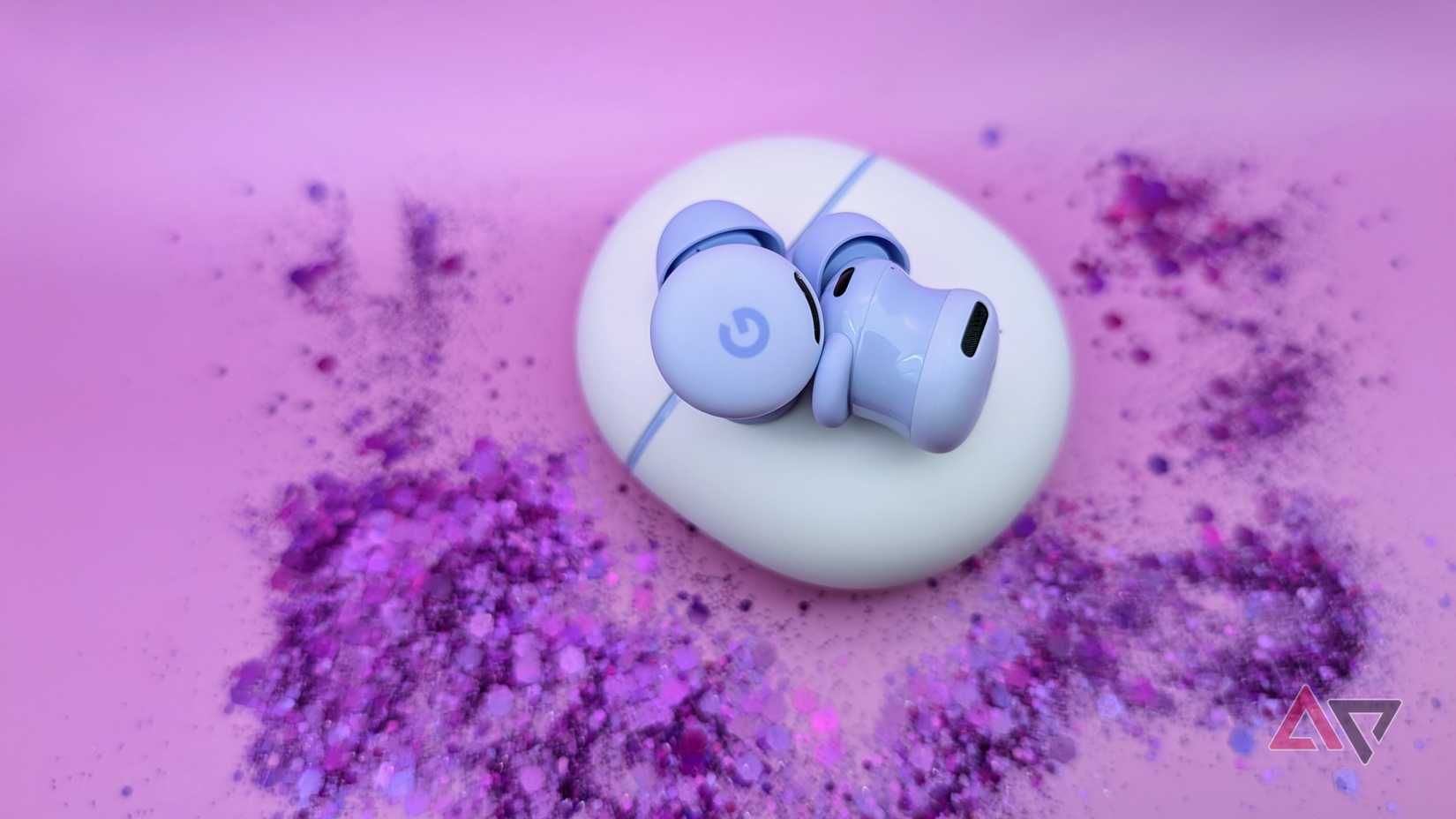 Google Pixel Buds 2a on case surrounded by purple glitter