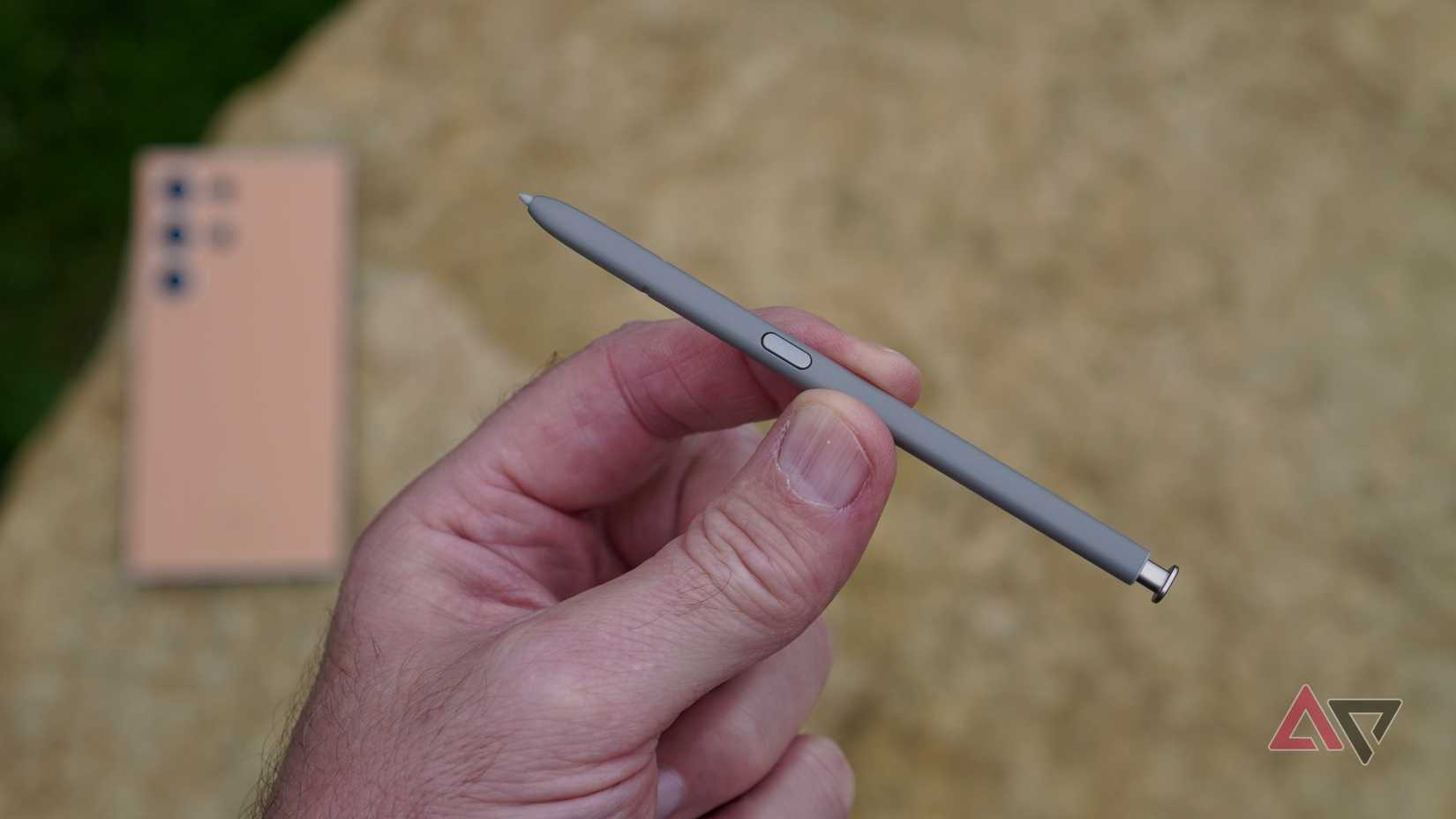 A person holding the S Pen stylus