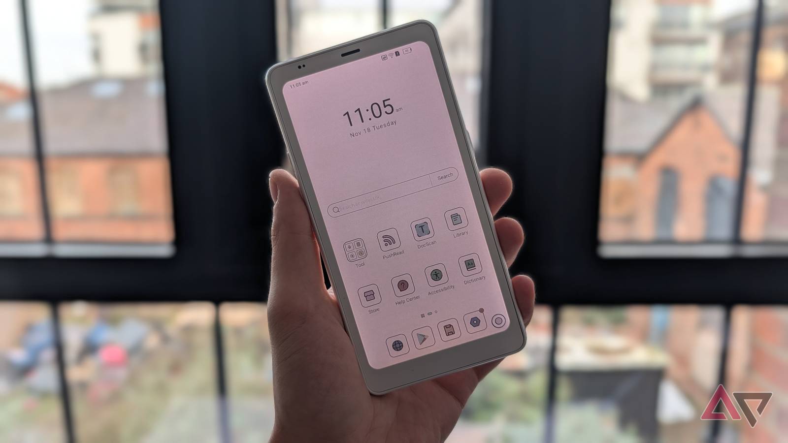 hand holding white e-reader showing apps