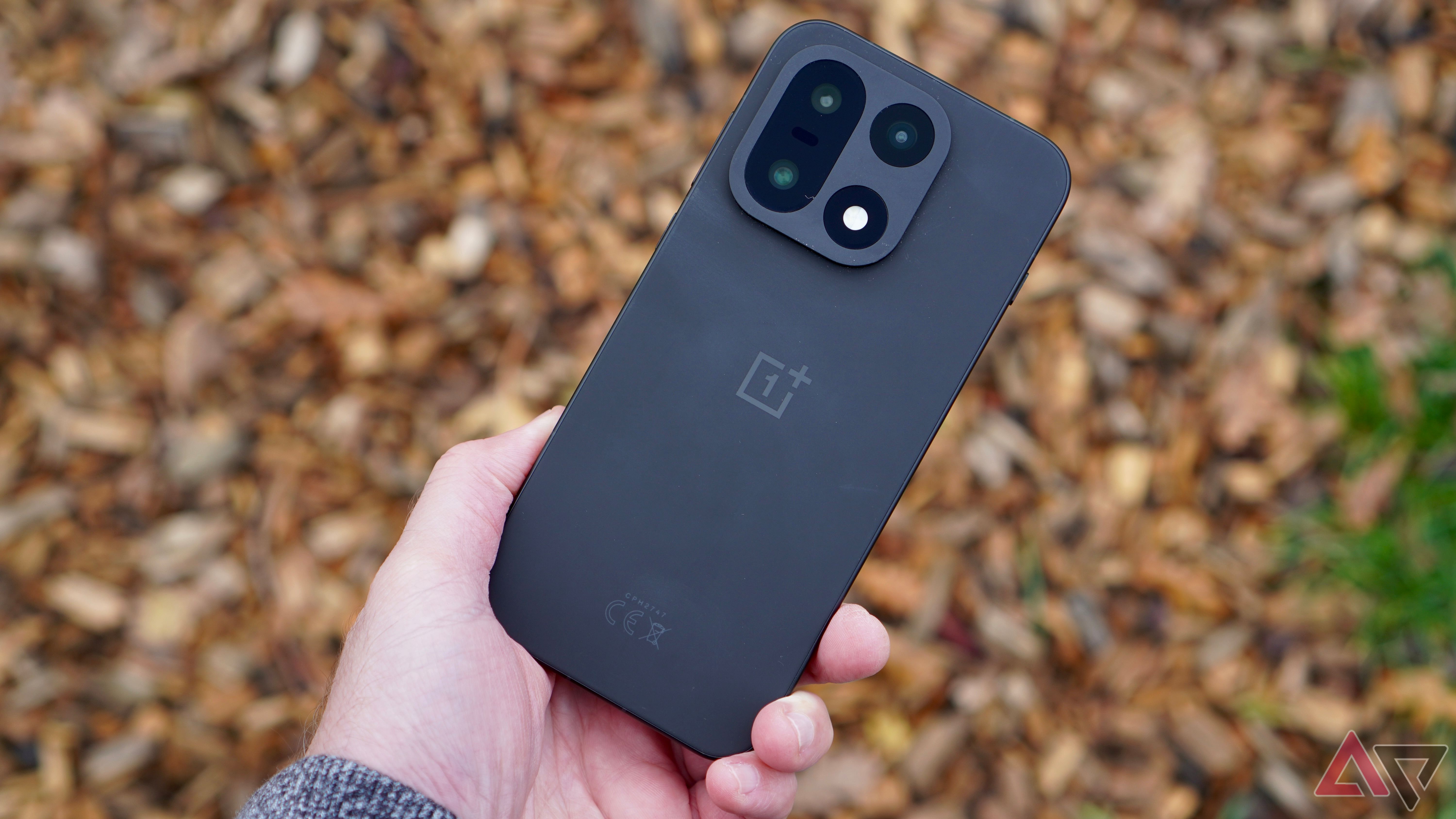 A person holding the OnePlus 15