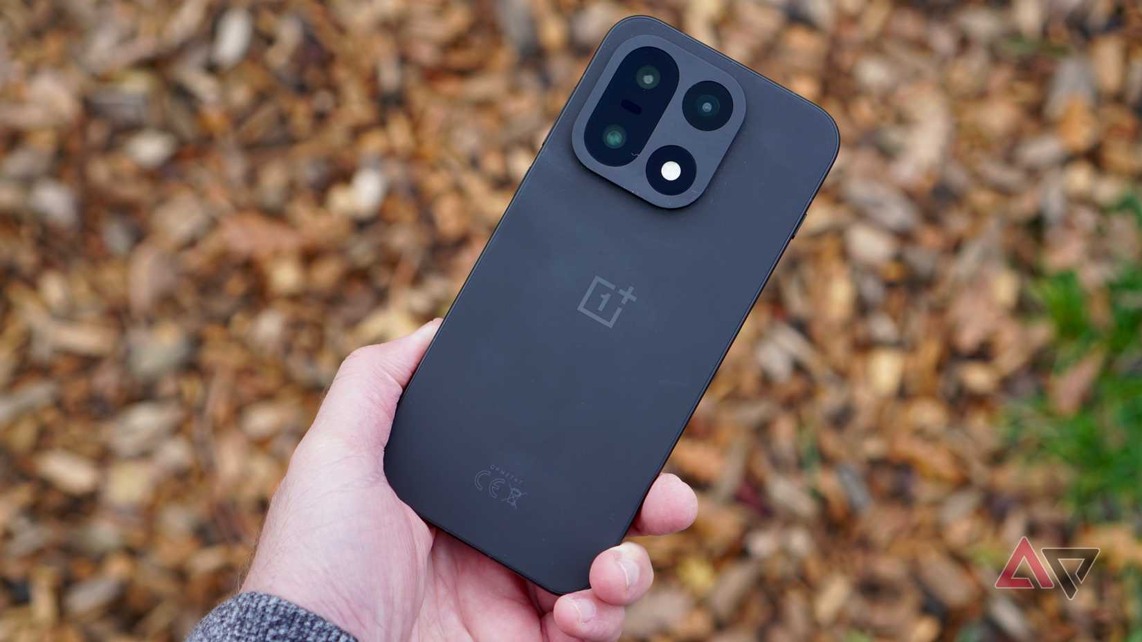 A person holding the OnePlus 15