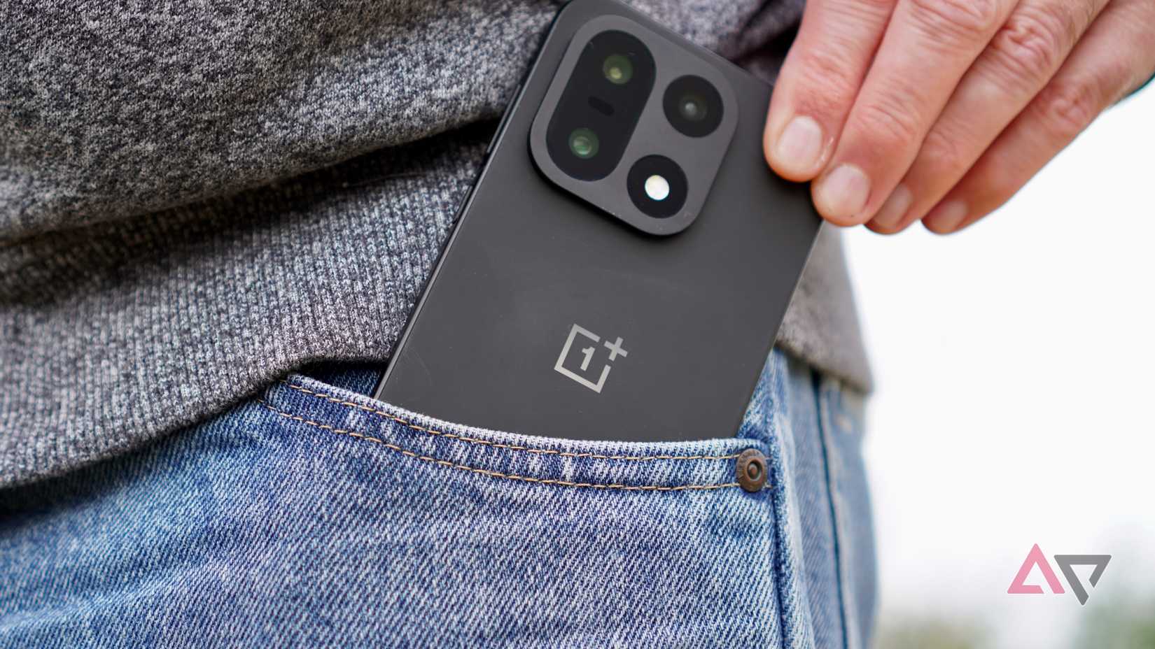 A person taking the OnePlus 15 out of a pocket