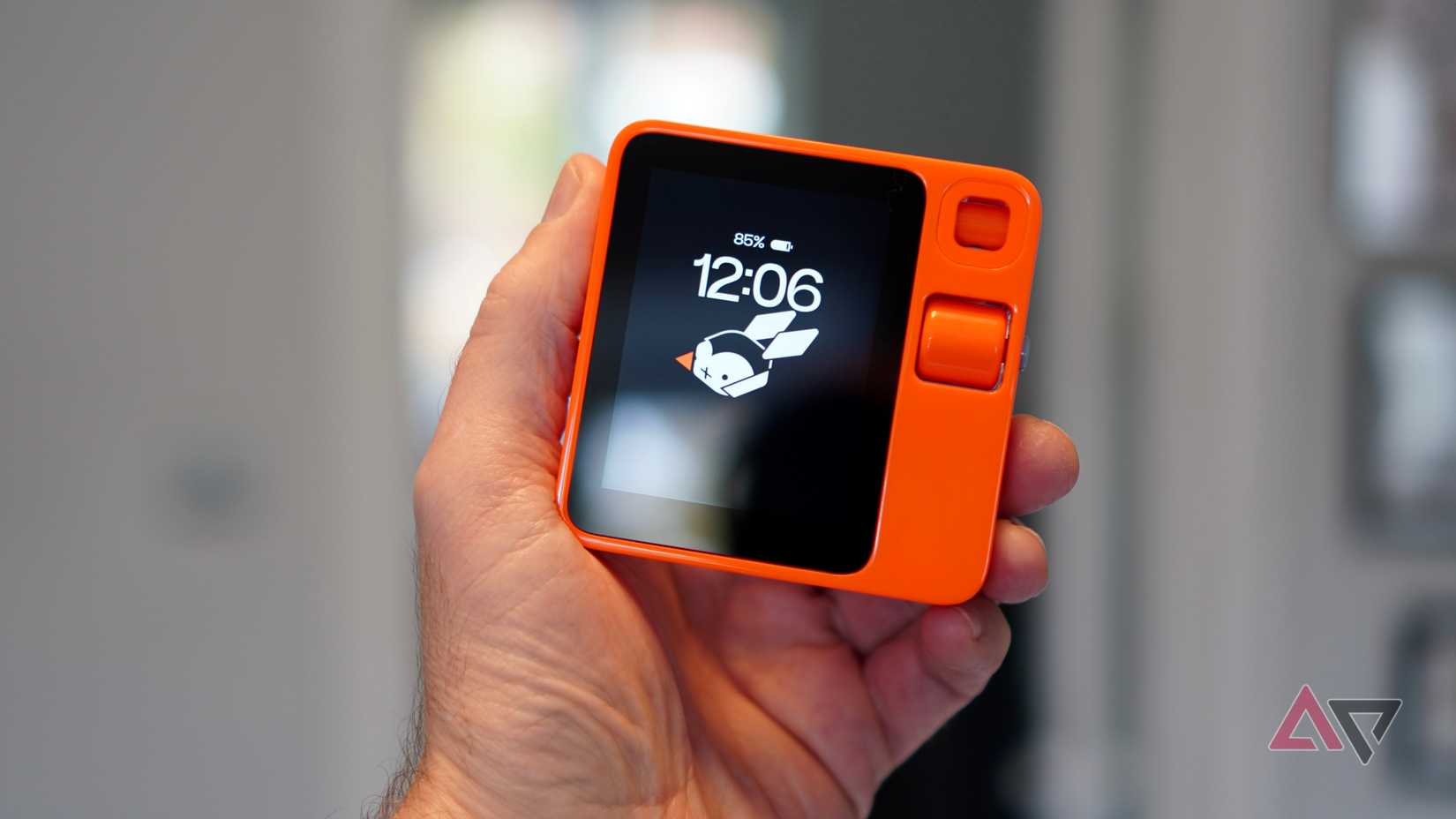 A person holding the Rabbit R1