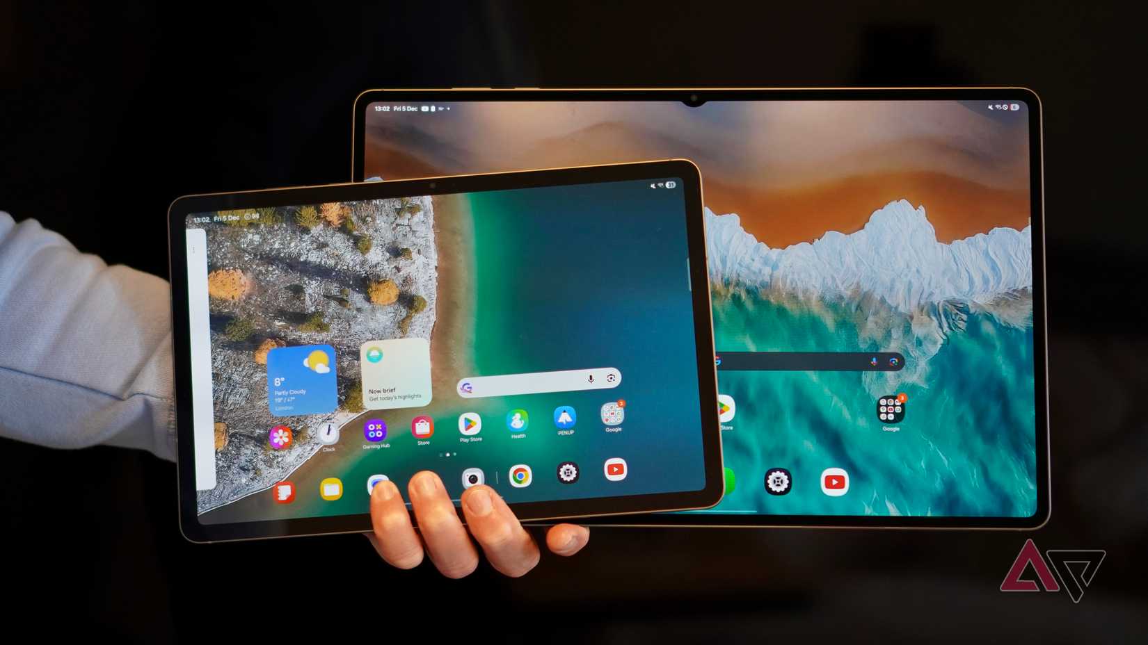 A person holding the Samsung Galaxy Tab S11 and Galaxy Tab S11 Ultra