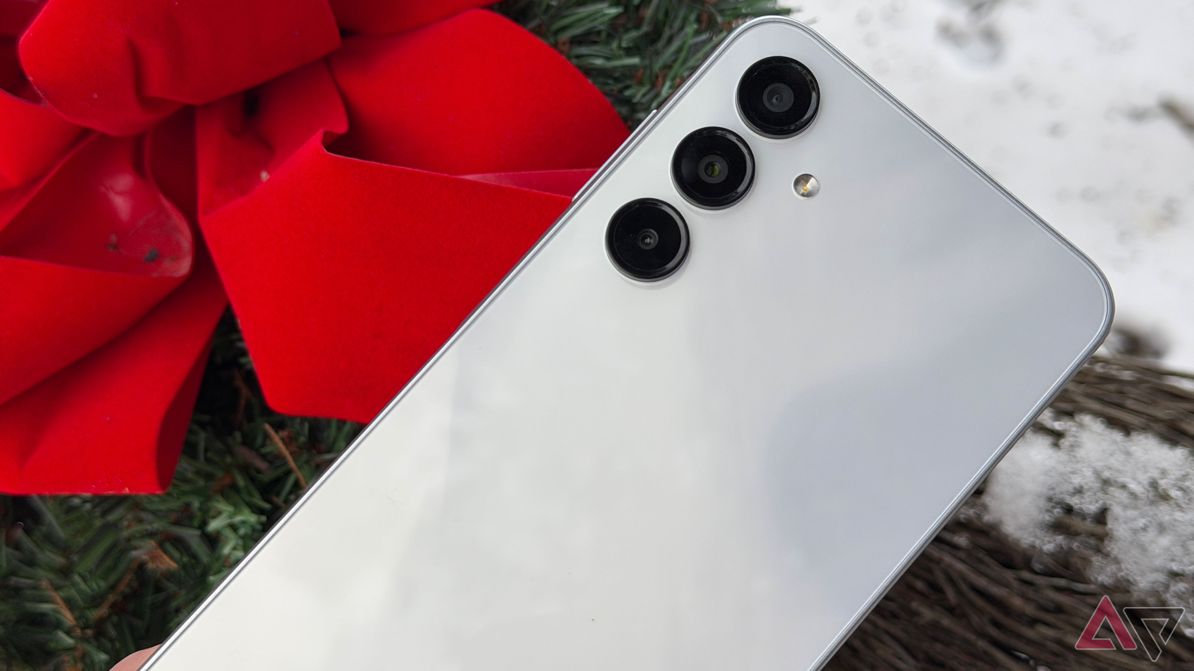 Samsung Galaxy A16 positioned next to a red bow