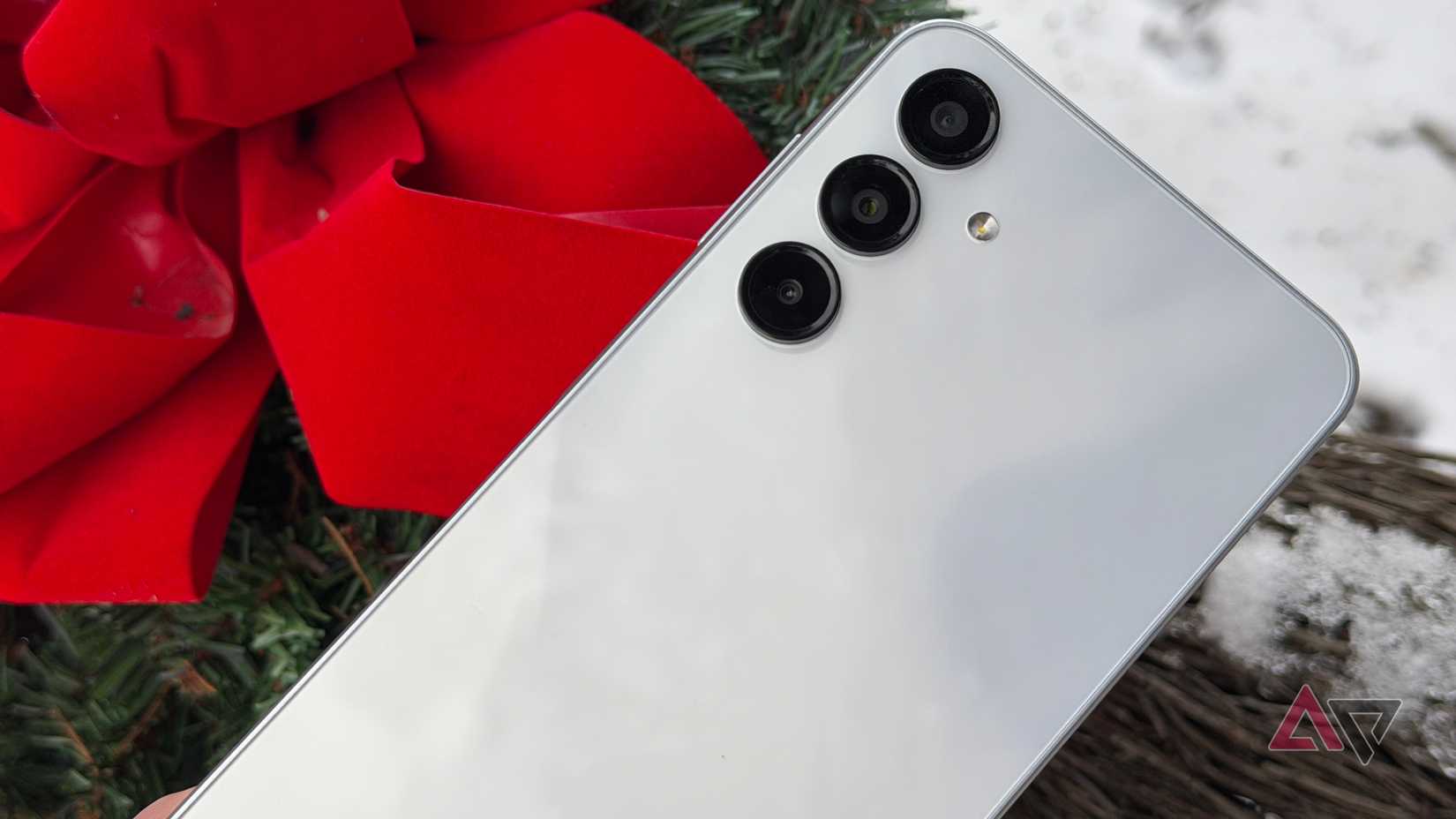 Samsung Galaxy A16 positioned next to a red bow