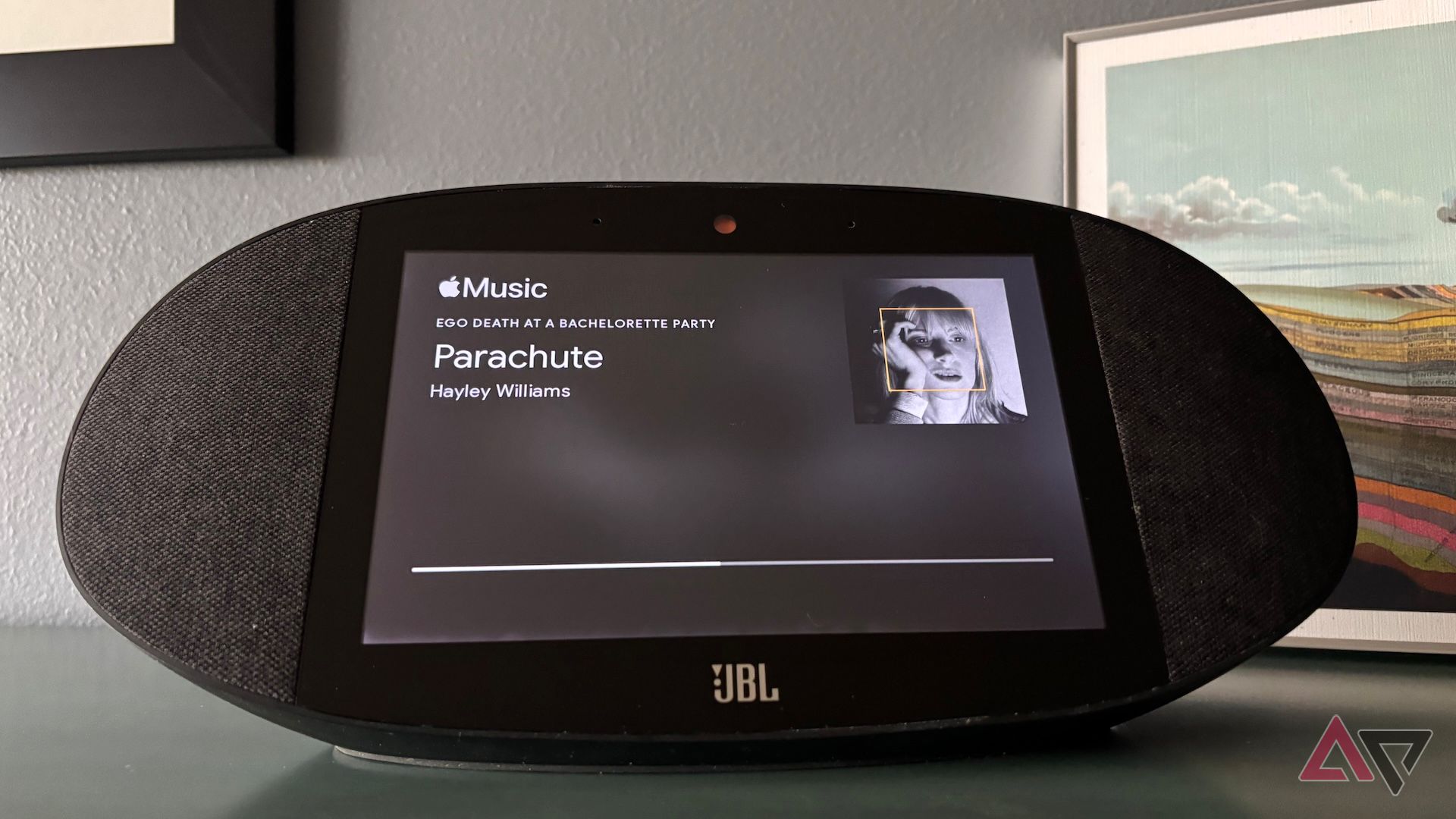 A Google Home JBL Speaker displaying the song Parachute by Hayley Williams on Apple Music.