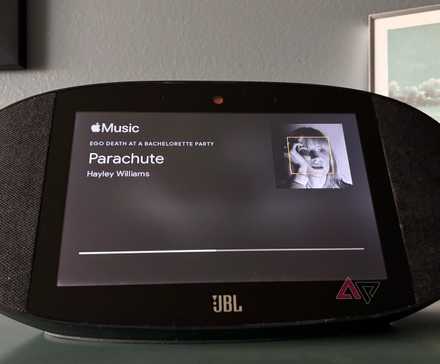 A Google Home JBL Speaker displaying the song Parachute by Hayley Williams on Apple Music.