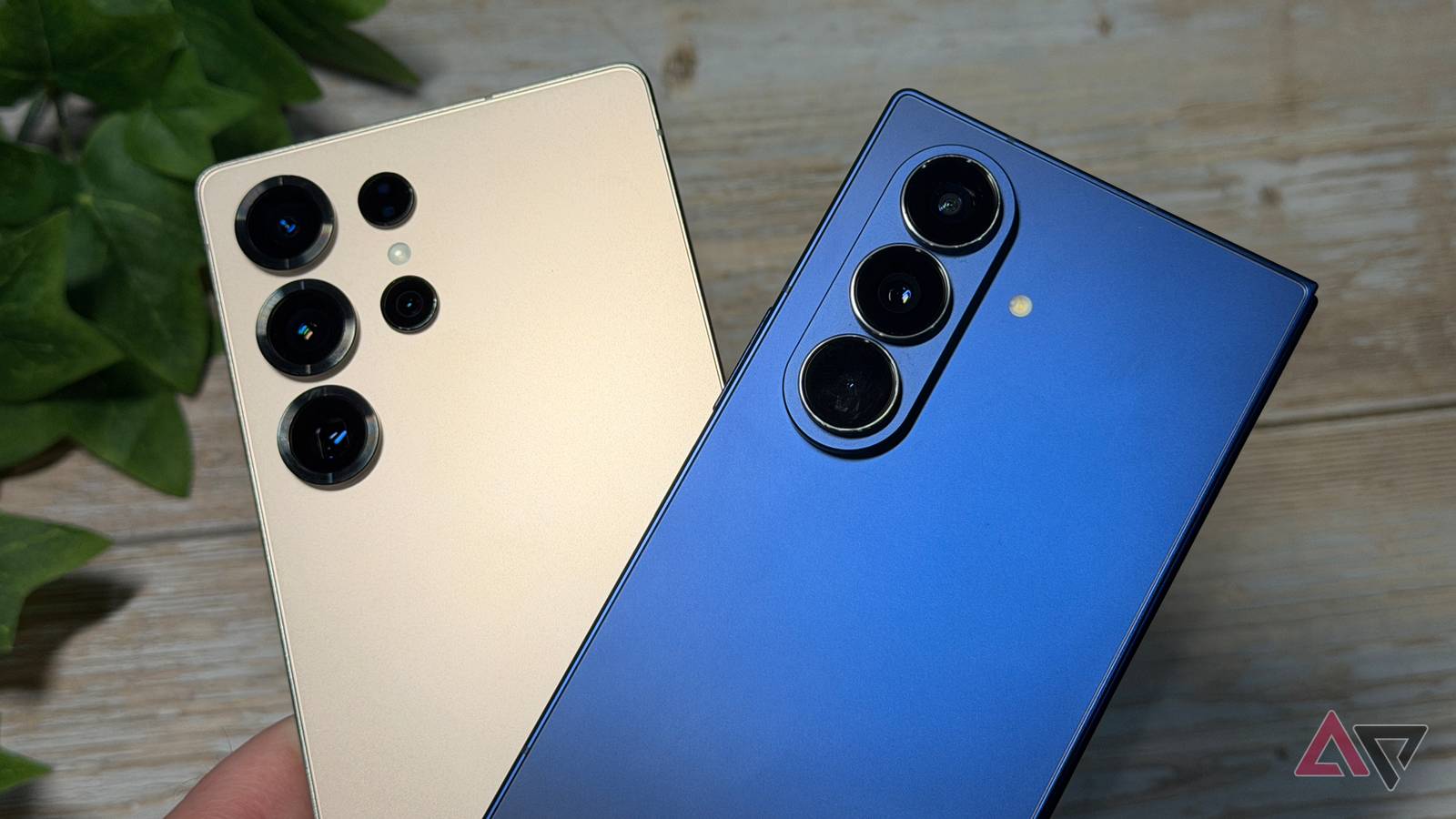 Samsung Galaxy S25 Ultra and Galaxy Z Fold 7 held up against a desk