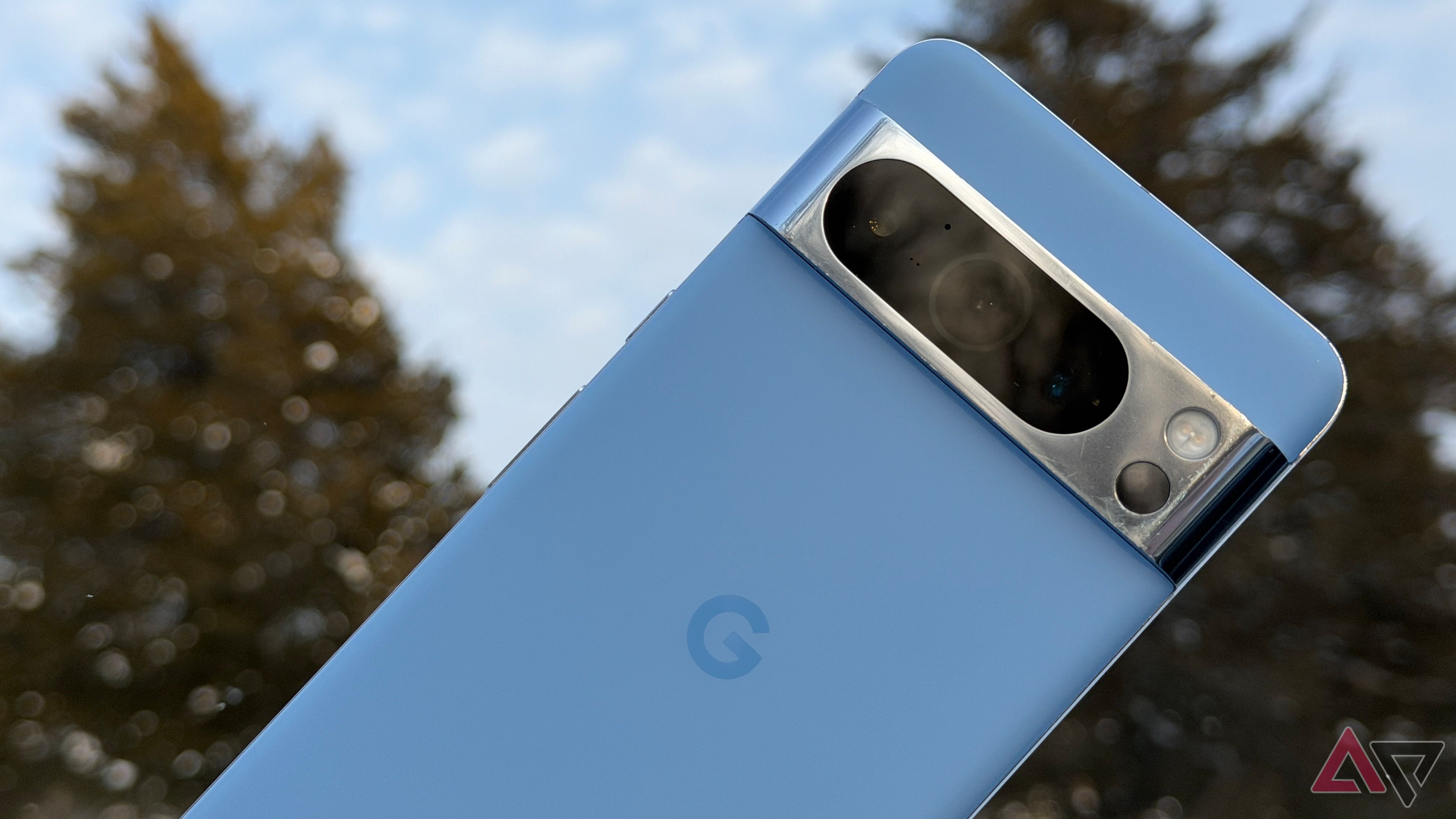 Google Pixel 8 Pro against a snowy tree backdrop