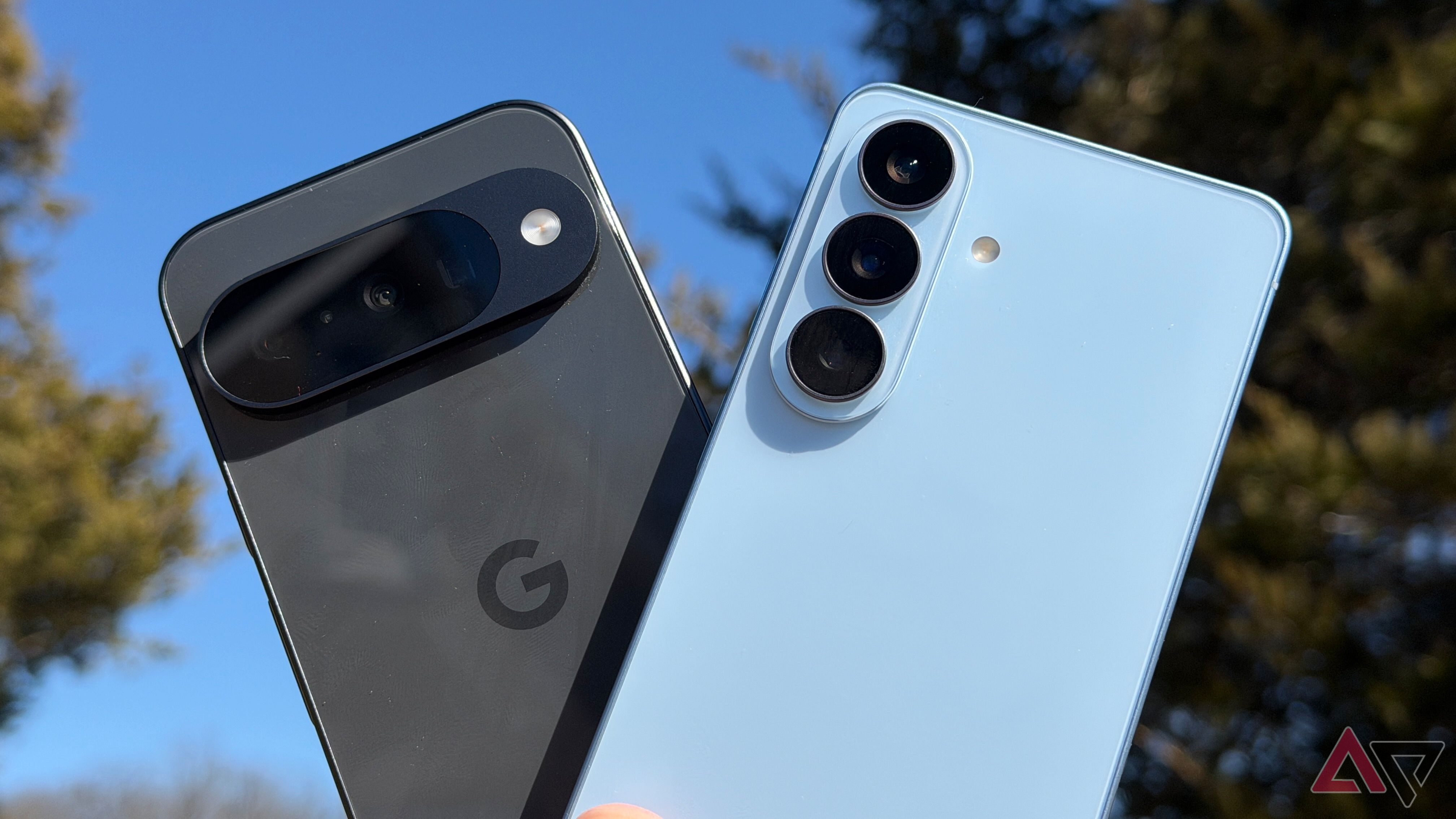 Samsung Galaxy S26 and Google Pixel 10 held up against sky