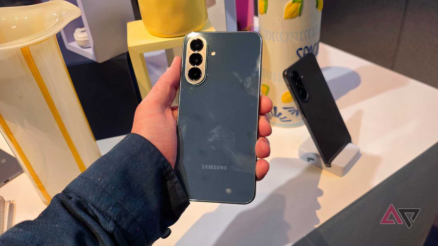 The green Samsung Galaxy A37 in a man's hand.