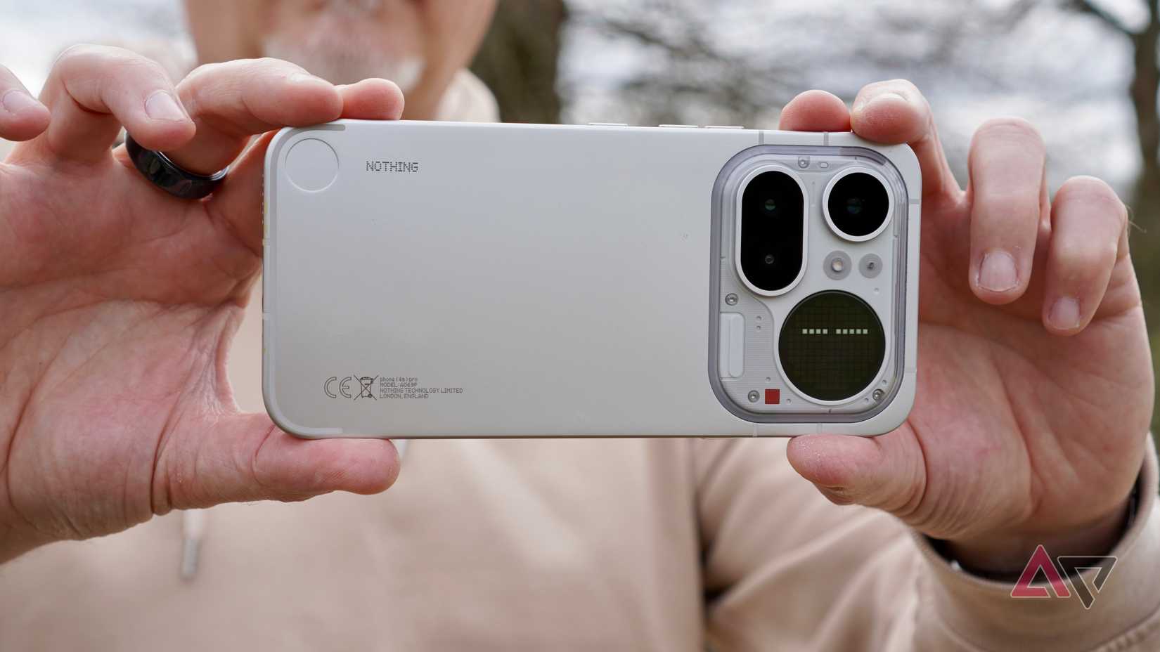 A person taking a photo with the Nothing Phone (4a) Pro
