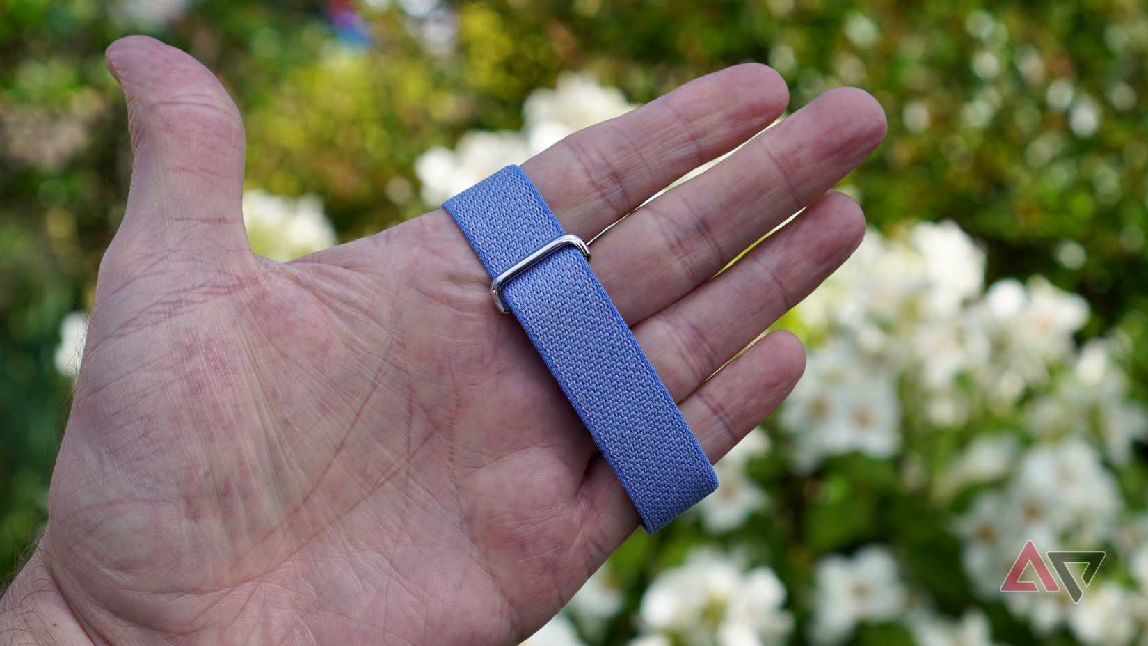 A person holding the Fitbit Air