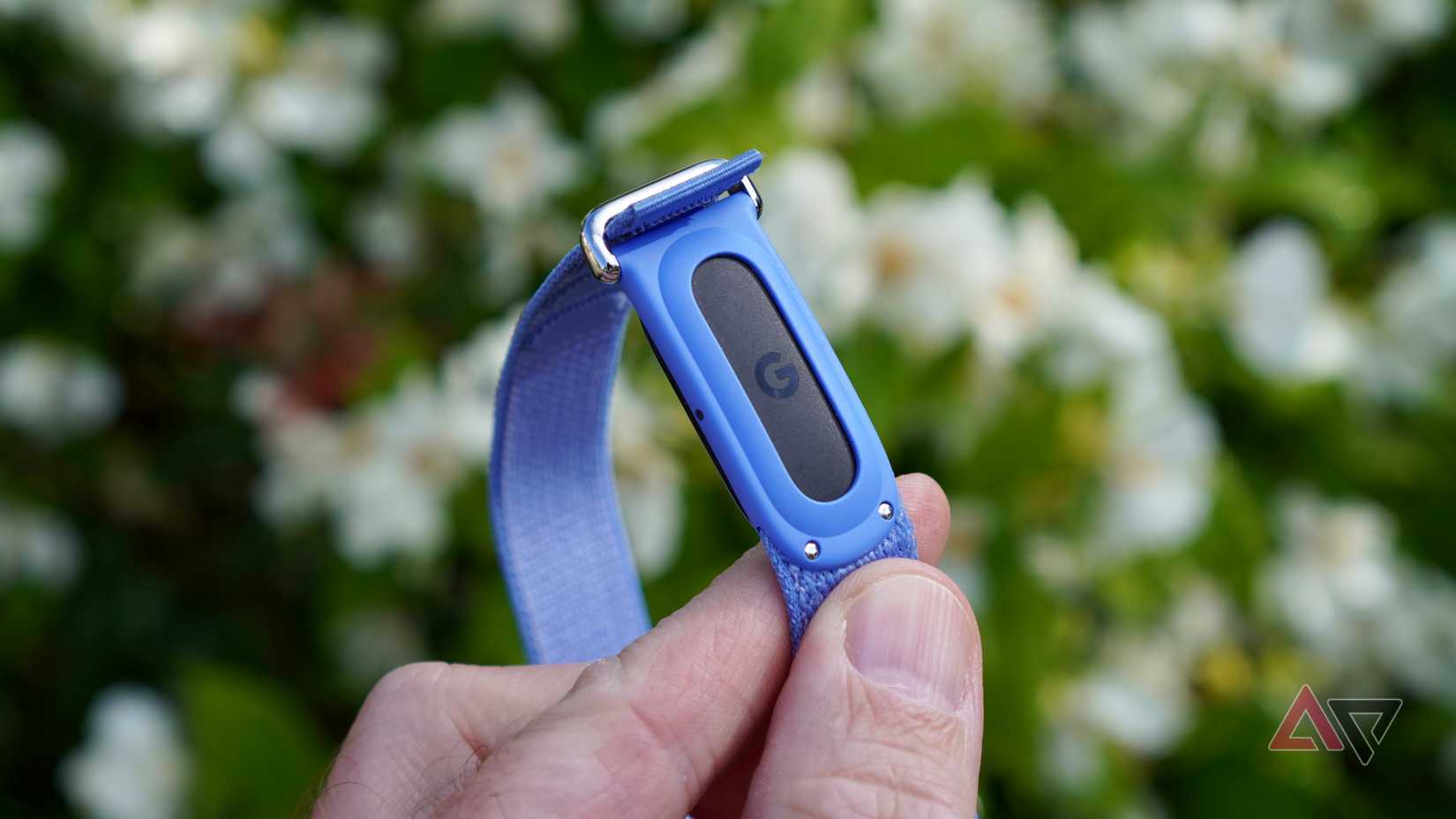 A person holding the Fitbit Air