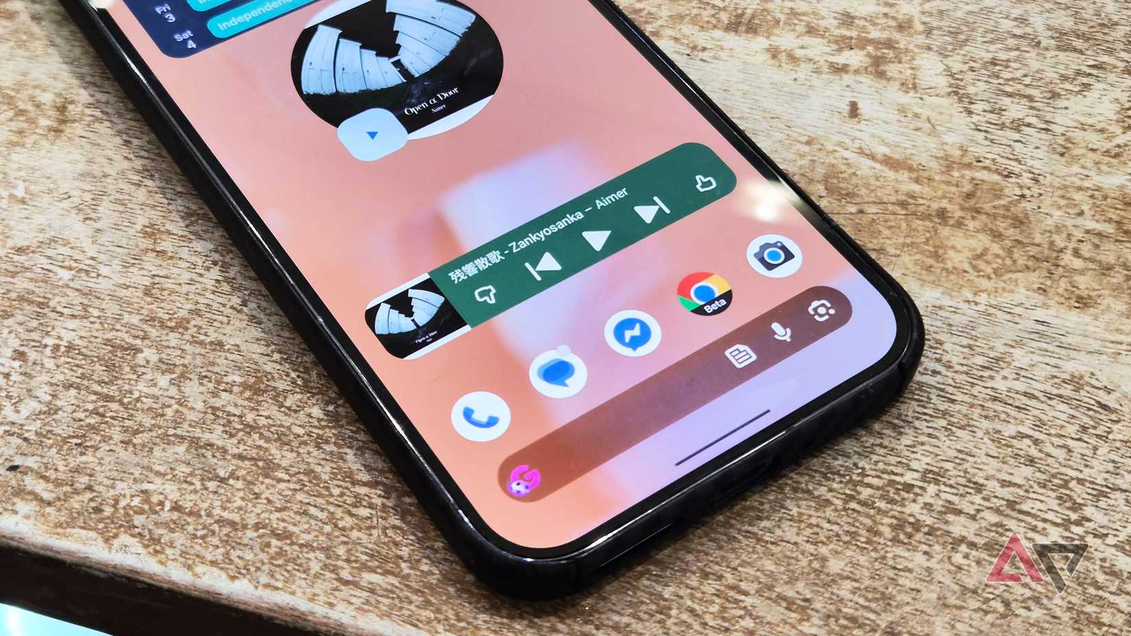 A home screen showing YouTube Music widget, search bar, and apps on a Google Pixel smartphone