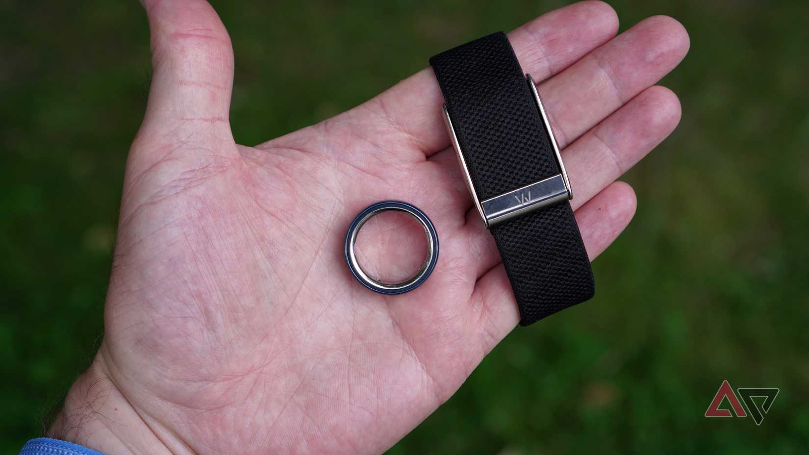 A person holding the Oura Ring and Whoop activity trackers