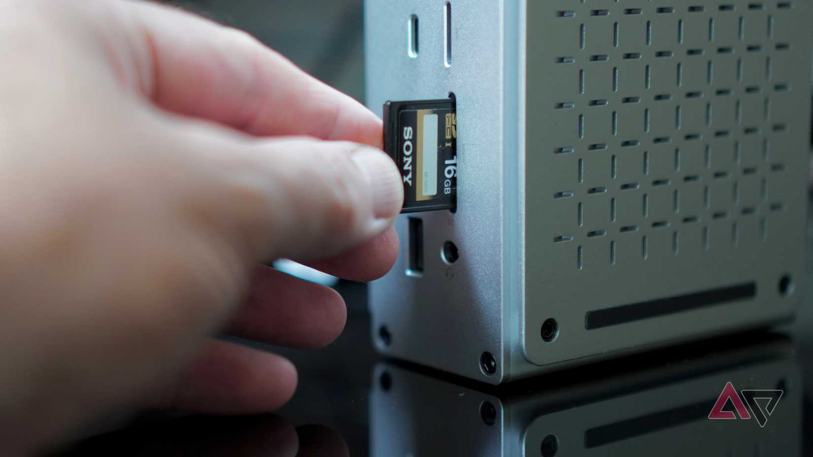 A person putting an SD card into the Keychron Thunderbolt 5 Docking Station