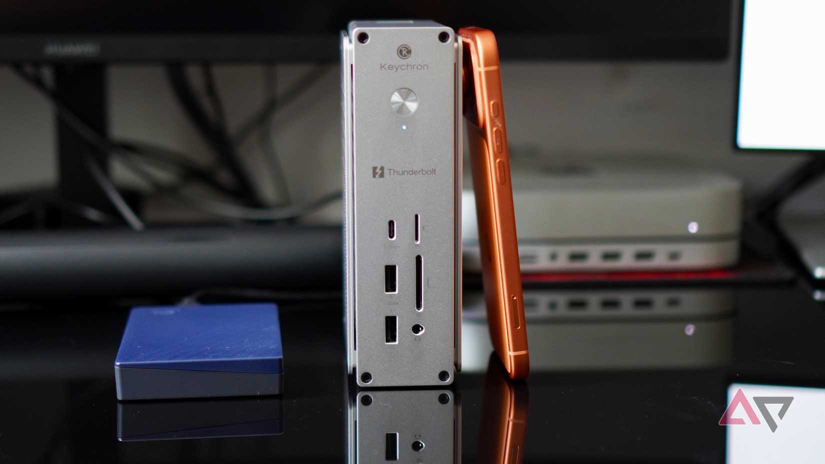 The Keychron Thunderbolt 5 Docking Station with an iPhone and hard drive