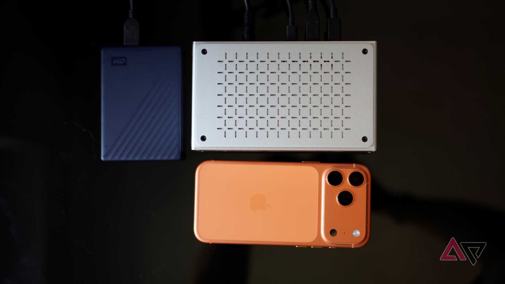The Keychron Thunderbolt 5 Docking Station with a hard drive and iPhone