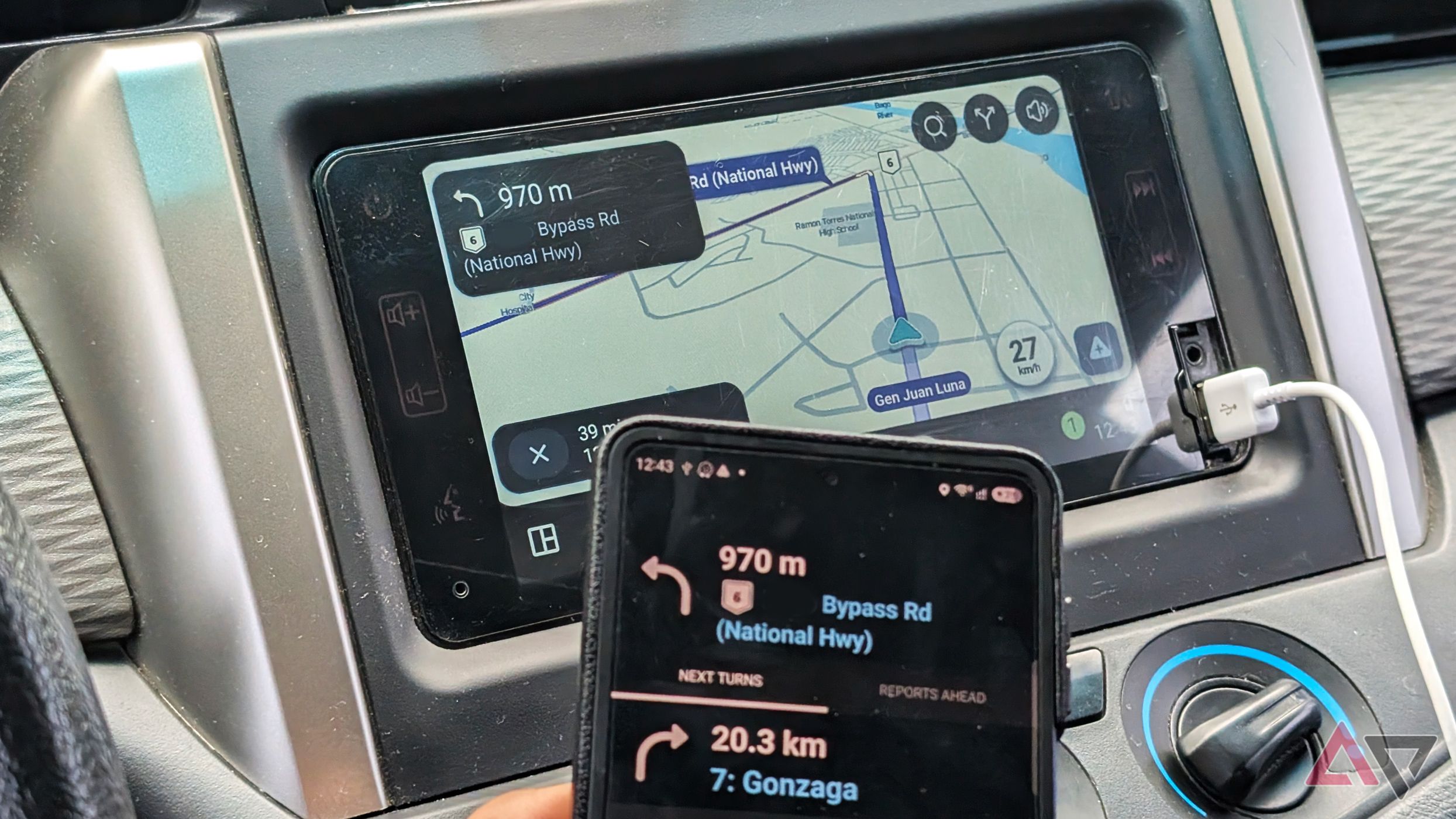 A smartphone with Waze app and a vehicle's infotainment display showing the navigation