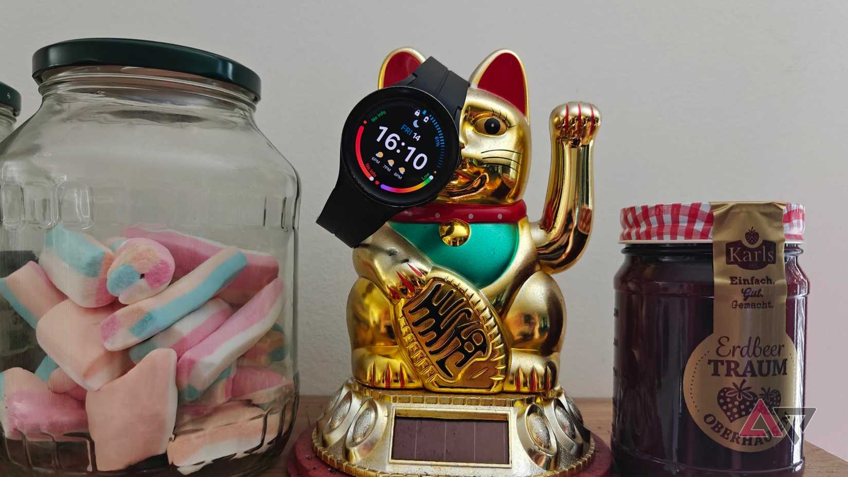Galaxy watch 5 pro resting on a lucky cat