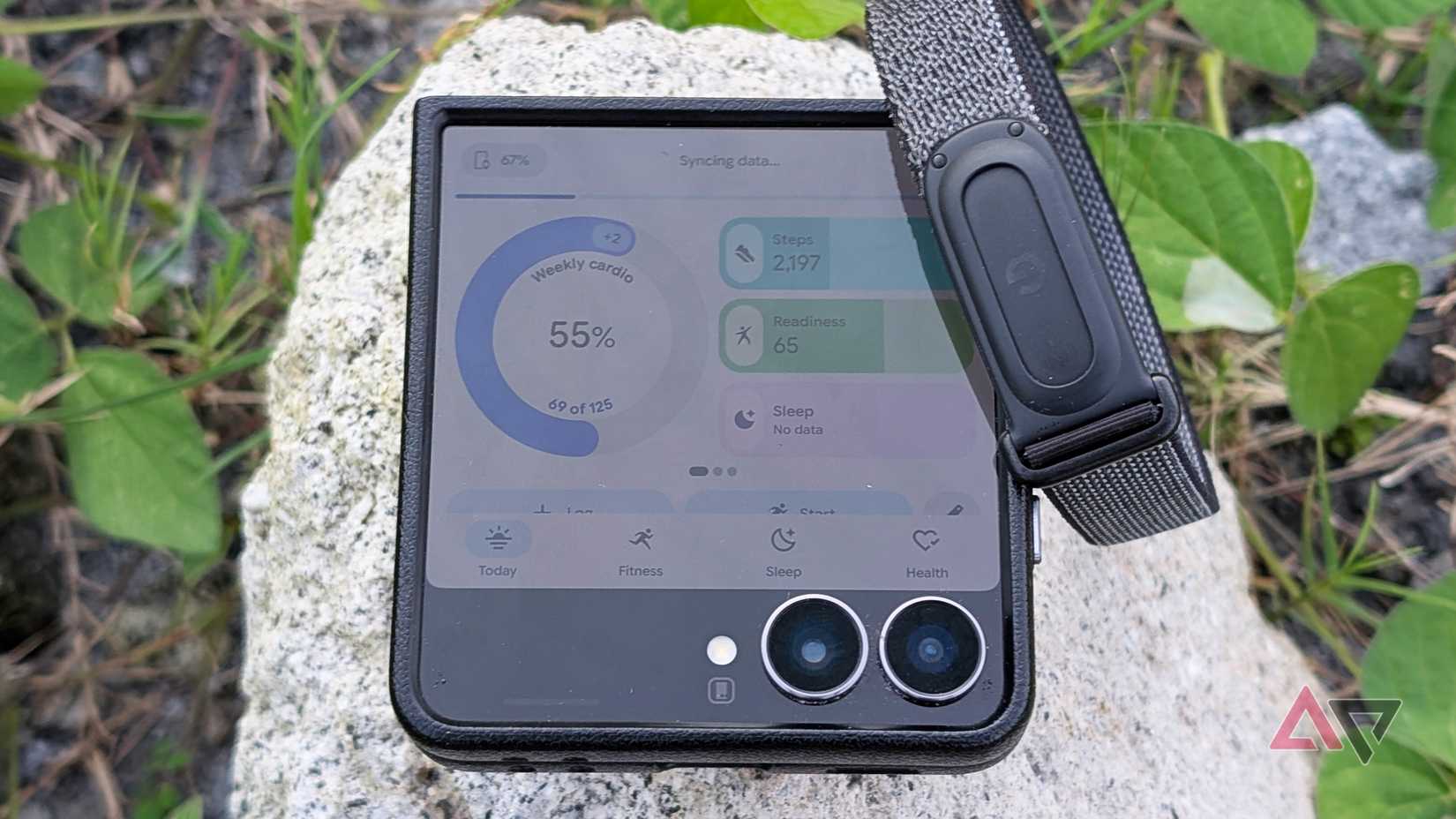 Samsung Galaxy Z Flip 7 smartphone paired with a Google Fitbit Air tracker