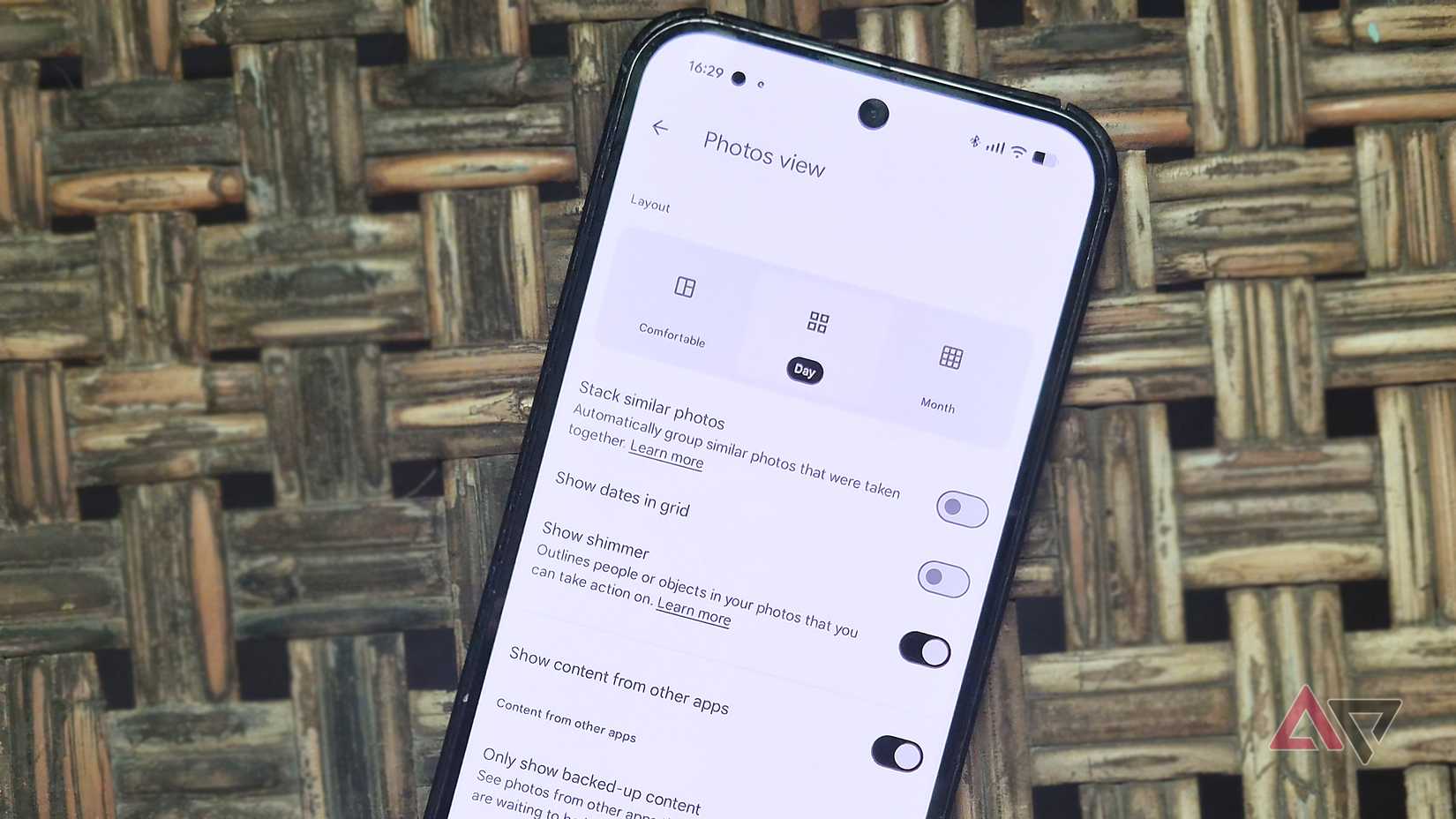 A Google Pixel phone showing Google Photos app's photo view settings