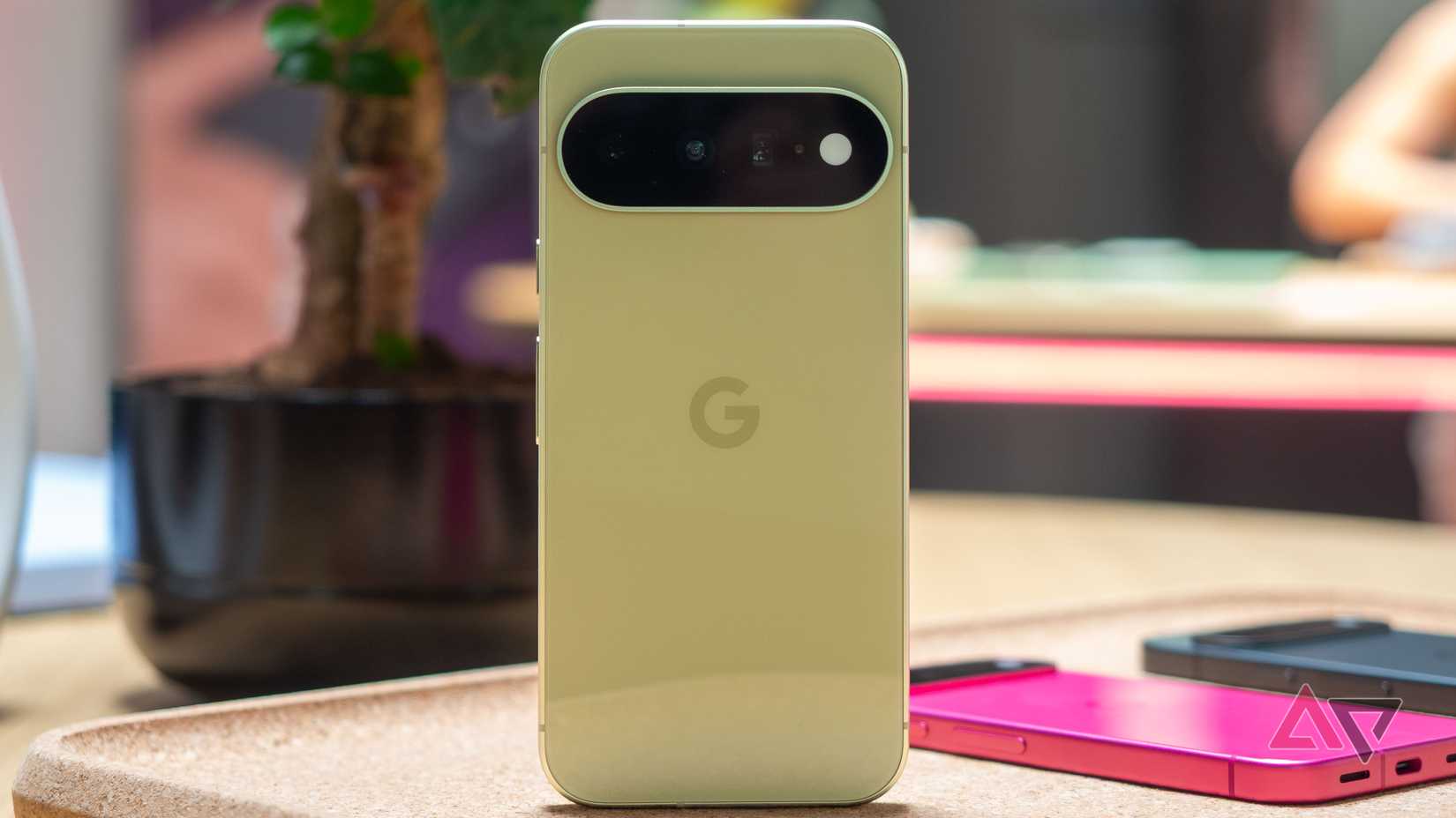 Google Pixel 11 in Pistachio, standing on a desk, seen from the back