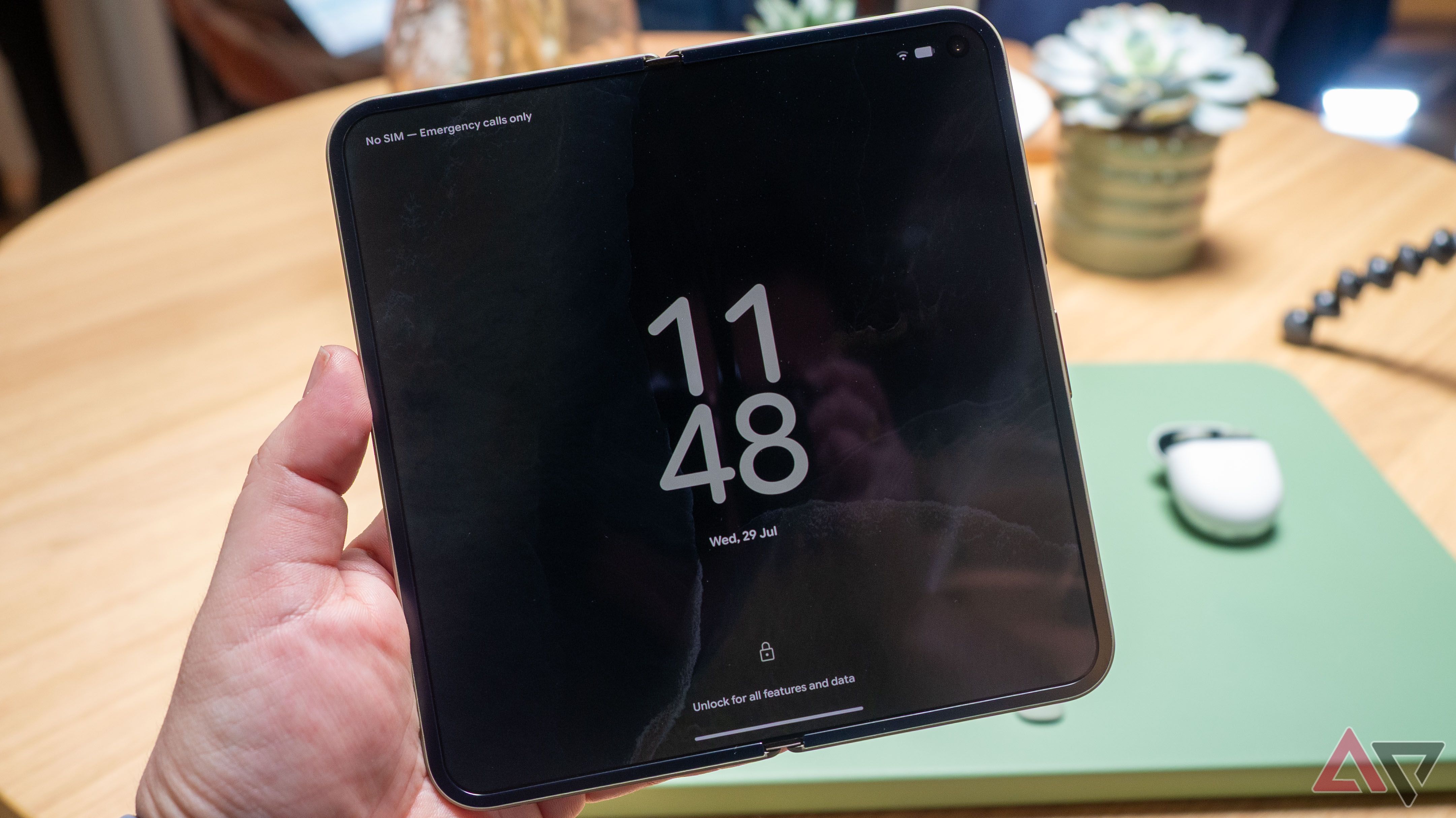 Google Pixel 11 Pro Fold in hand, unfolded, showing the always-on-display