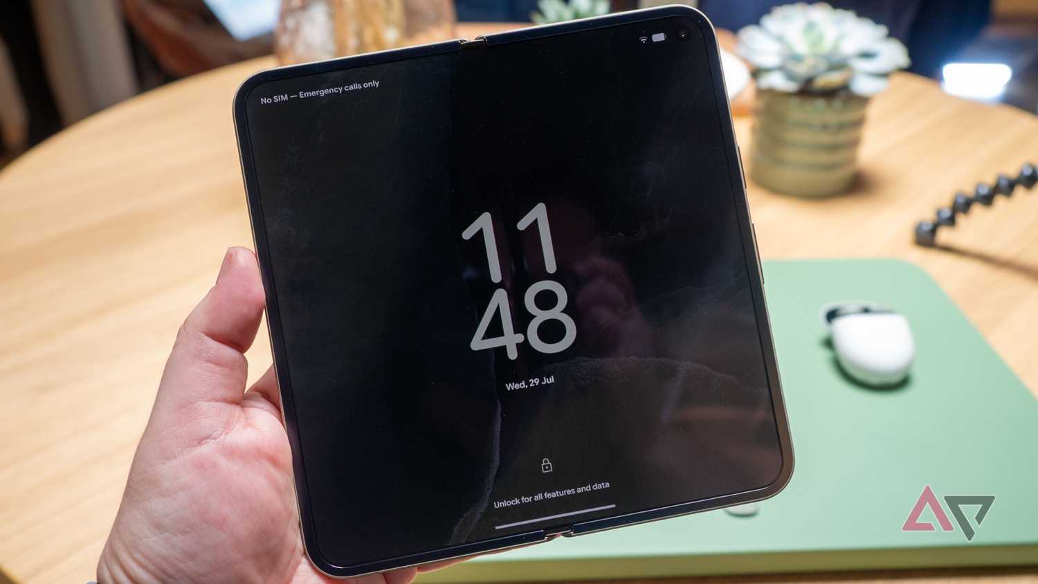 Google Pixel 11 Pro Fold in hand, unfolded, showing the always-on-display