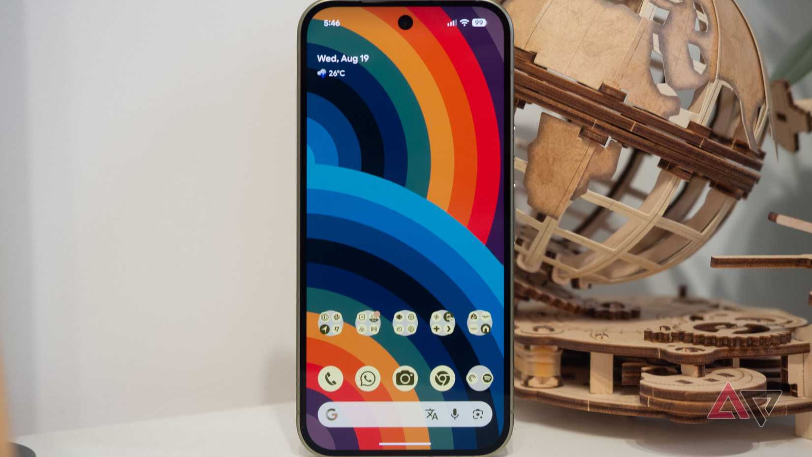 Google Pixel 11 on table, screen on, homescreen setup
