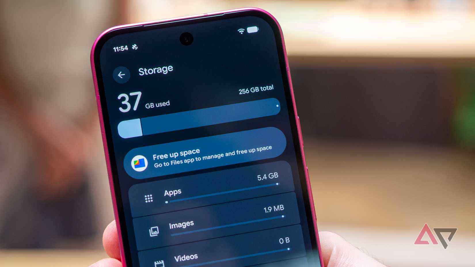 Google Pixel 11 in hand showing the phone's 258GB storage