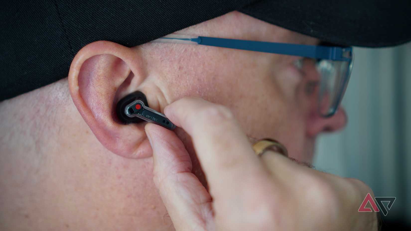 A person using the Nothing Ear (3a)
