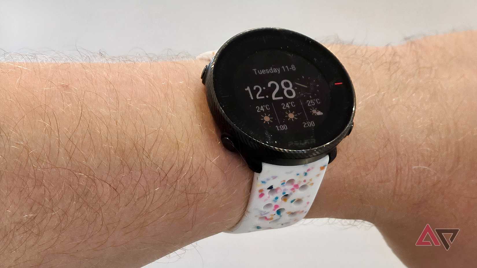 The Polar Vantage M2 on a man's wrist with a colorful third-party band.