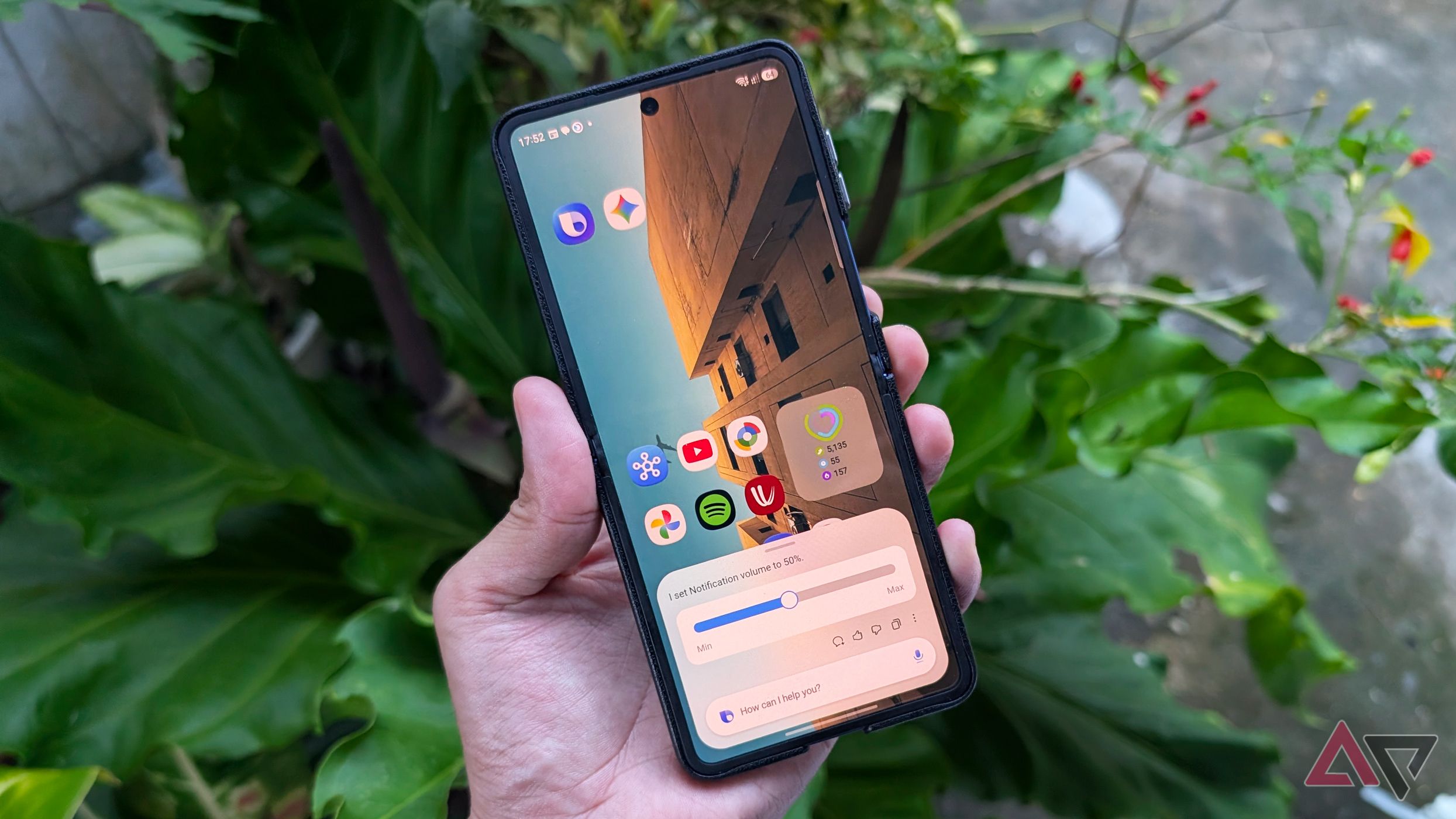 Samsung Galaxy Z Flip 7 smartphone with Bixby and Gemini on its homescreen along with Google apps