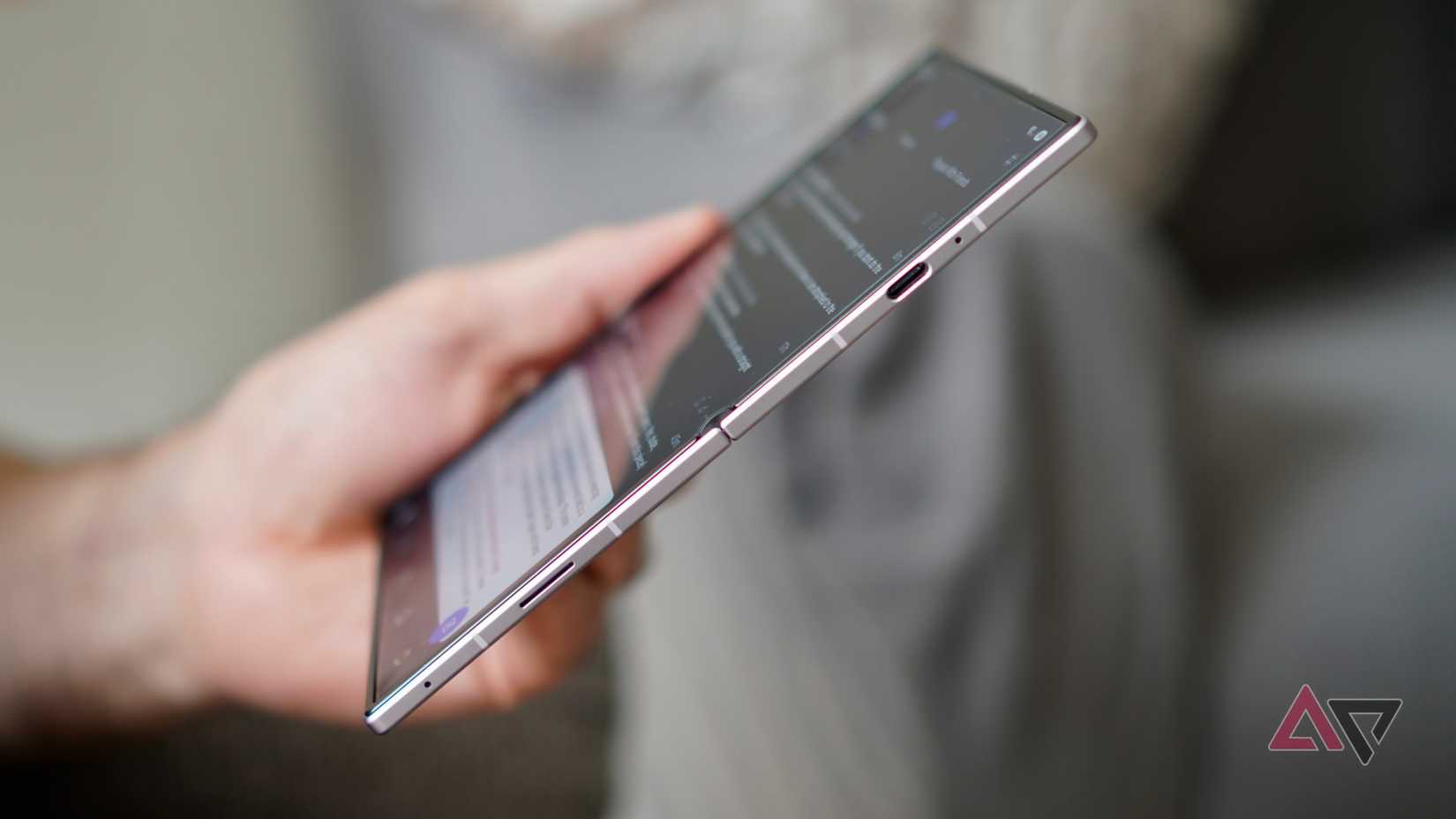 A person holding the open Samsung Galaxy Z Fold 8