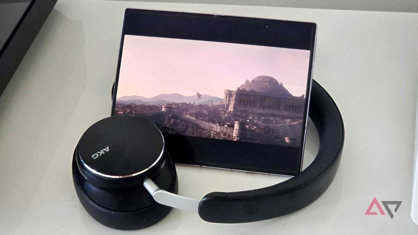 An unfolded Samsung Galaxy Z Fold 8 nestled in headphones, playing House of Dragons.